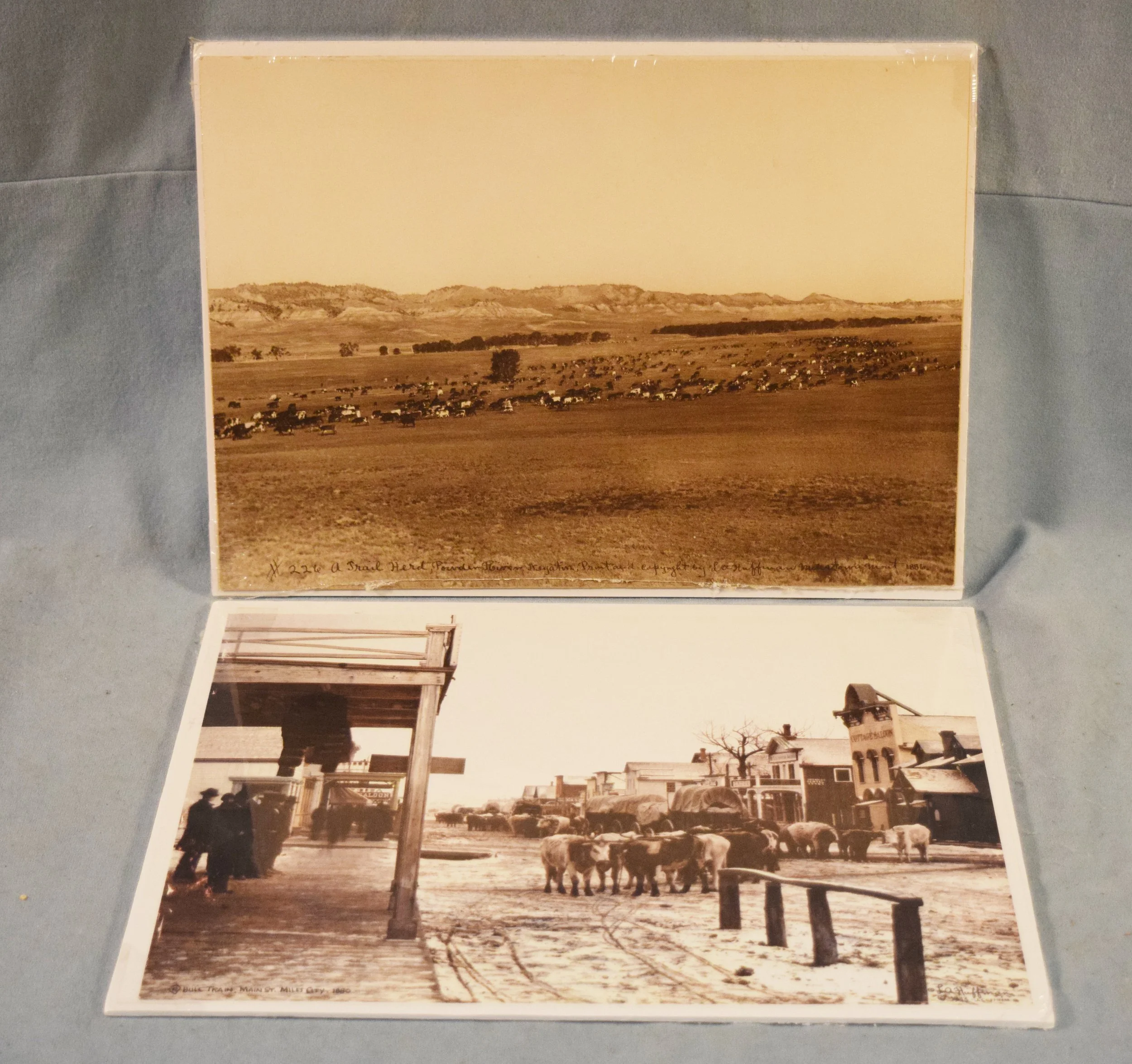 (2) L.A. Huffman prints:  #226 A Trail Herd, Powder River, 1886, 10" x 15.5" & Bull Train - Main Street Miles City 1880, 11" x 13.5", copyright 1913