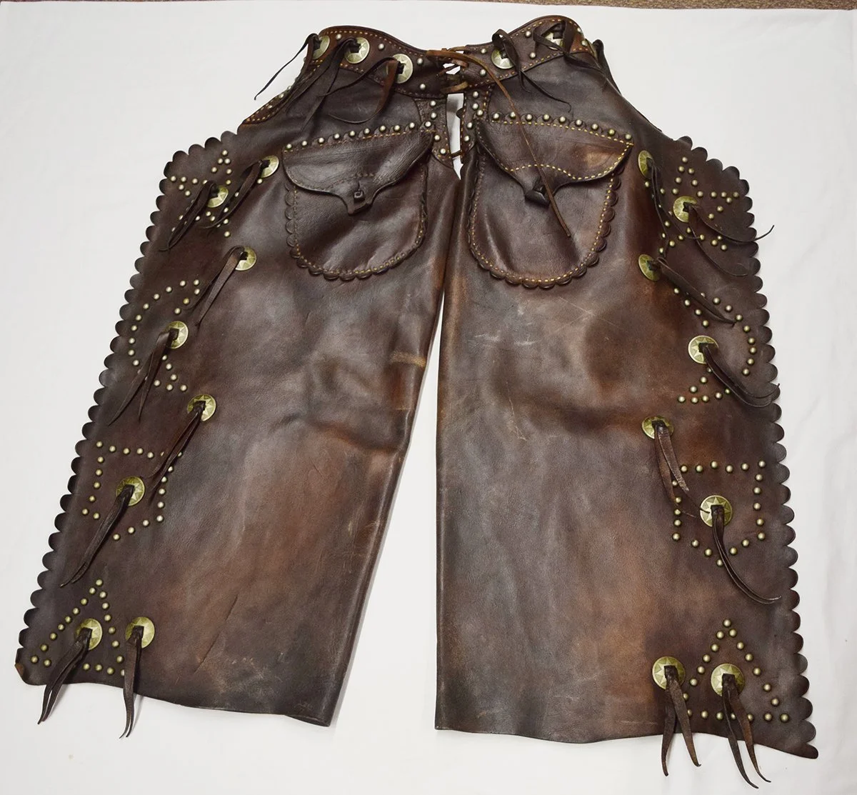R. T. Frazier heavy studded batwing chaps w/outside pockets and pinking down the wings and pockets. Very high condition.
