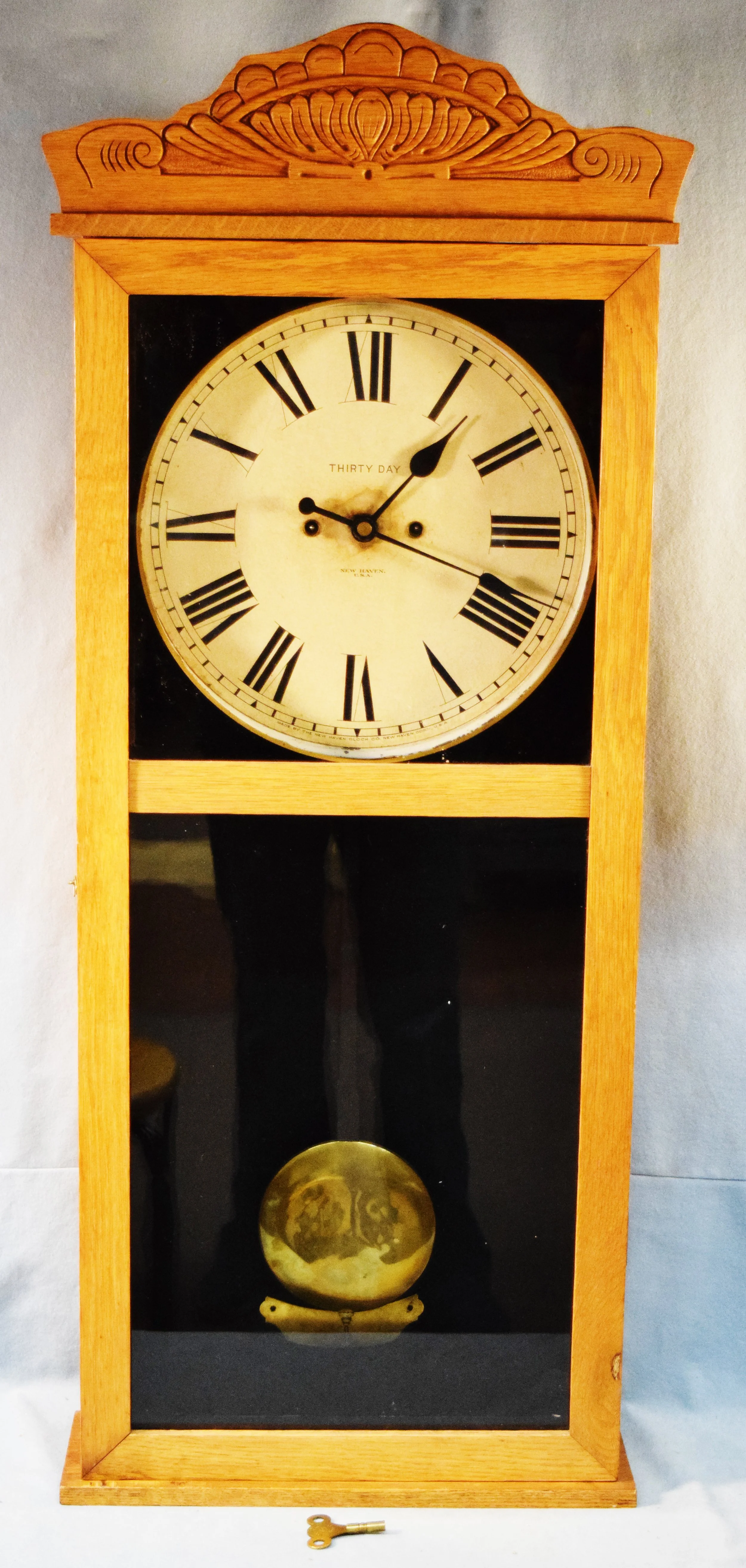 New Haven 30 Day Pendulum Clock, oak cased with key, 39" x 15" x 5.5"