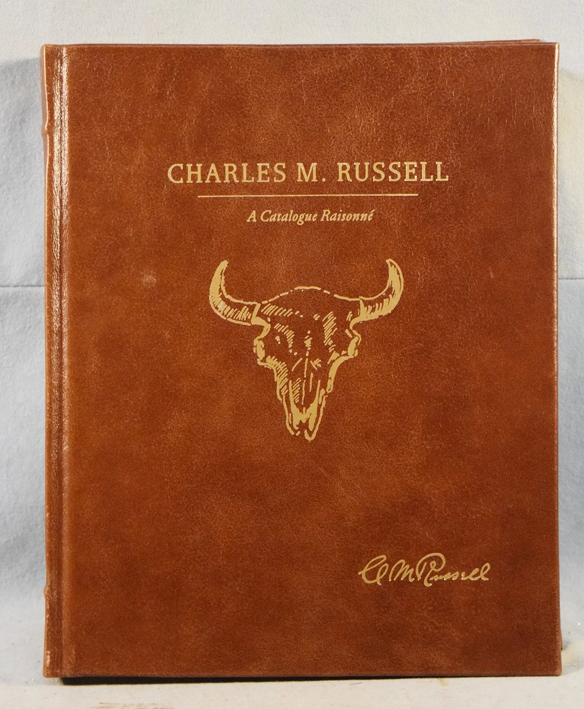 Charles M. Russell, A Catalogue Raisonne, edited by Byron Price, limited edition, #87/500, leather bound in slip cover, signed by the seven contributors, mint condition, very collectible
