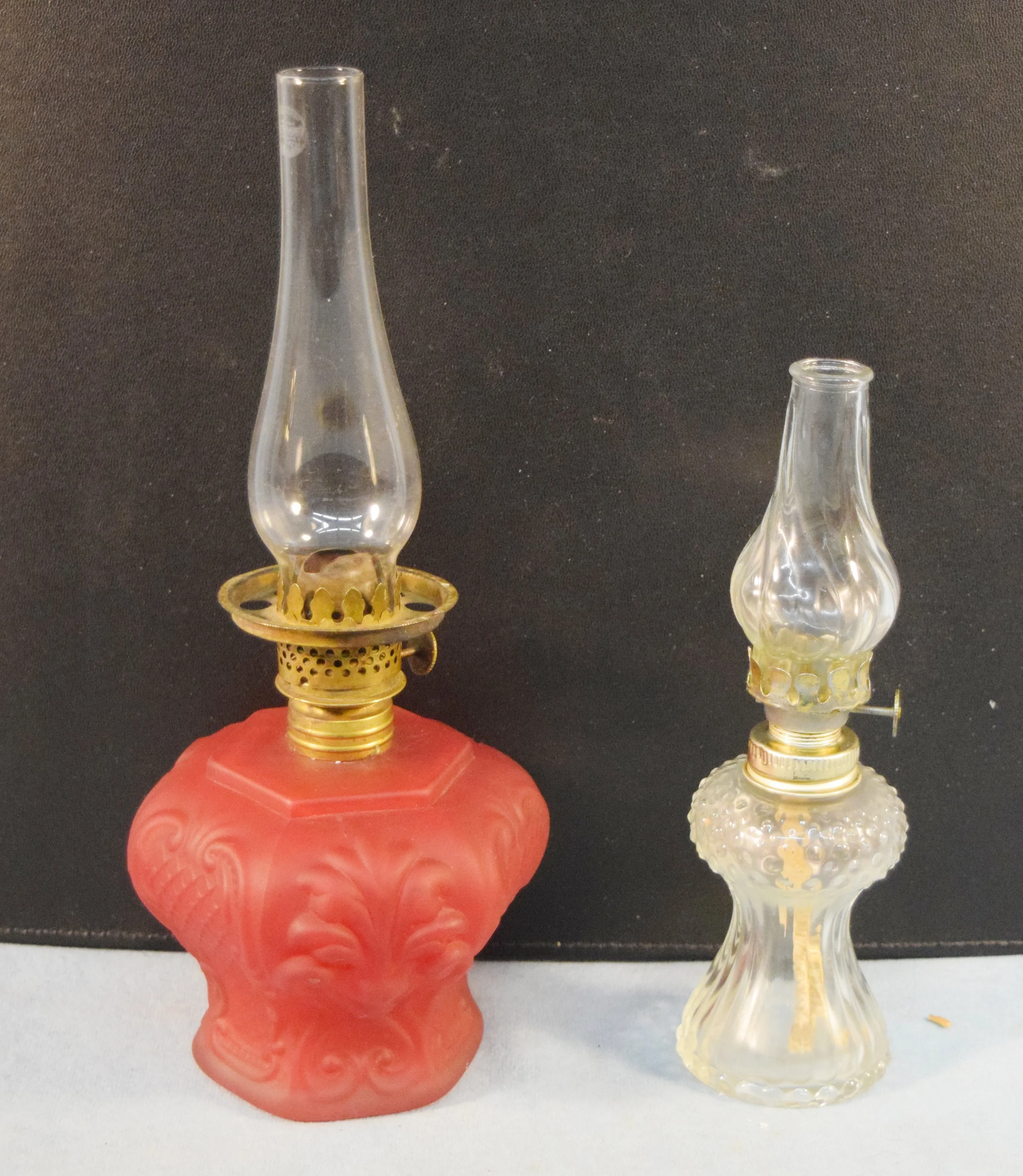2 pcs: Vintage red oil lamp, 10.5" tall & vintage clear oil lamp, 8.5" tall