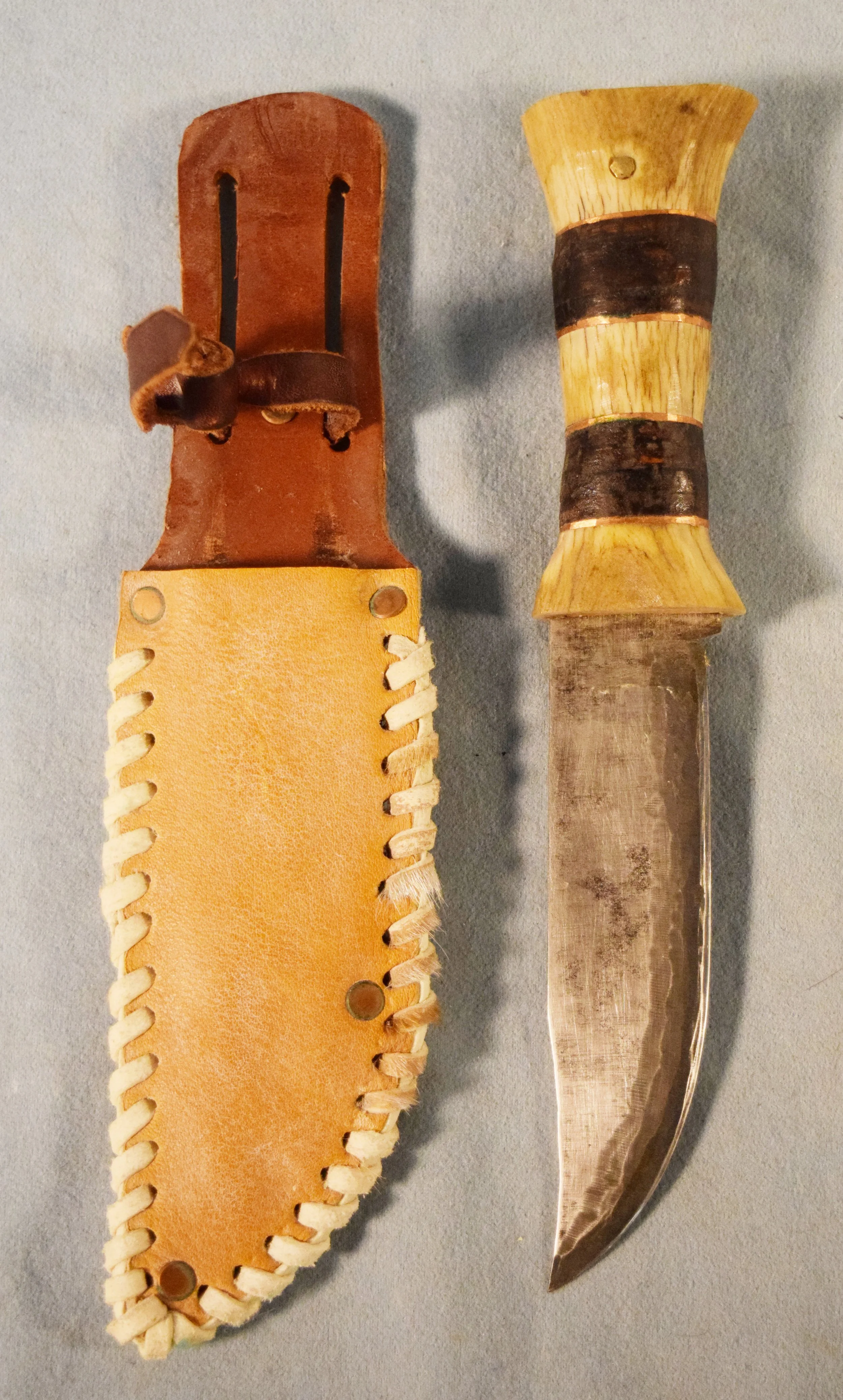 Elk antler handle knife in leather sheath, blade is 5.25", old