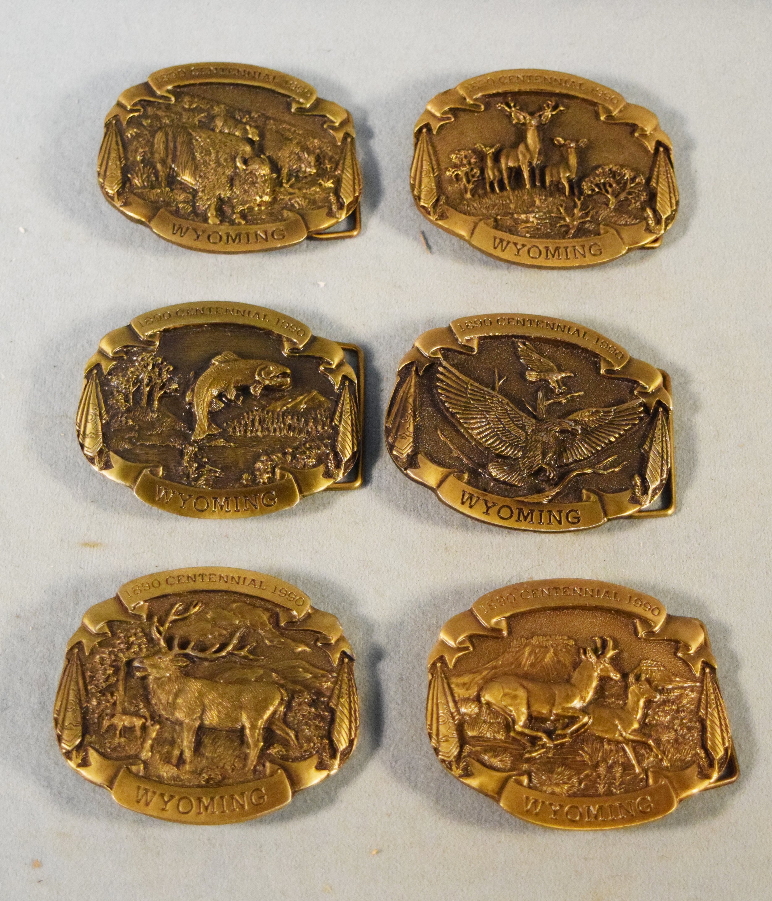 (6) Wyoming Centennial Collector's Belt Buckles, solid bronze, all #141/3000, pronghorn, elk, bald eagle, mule deer, trout & buffalo.