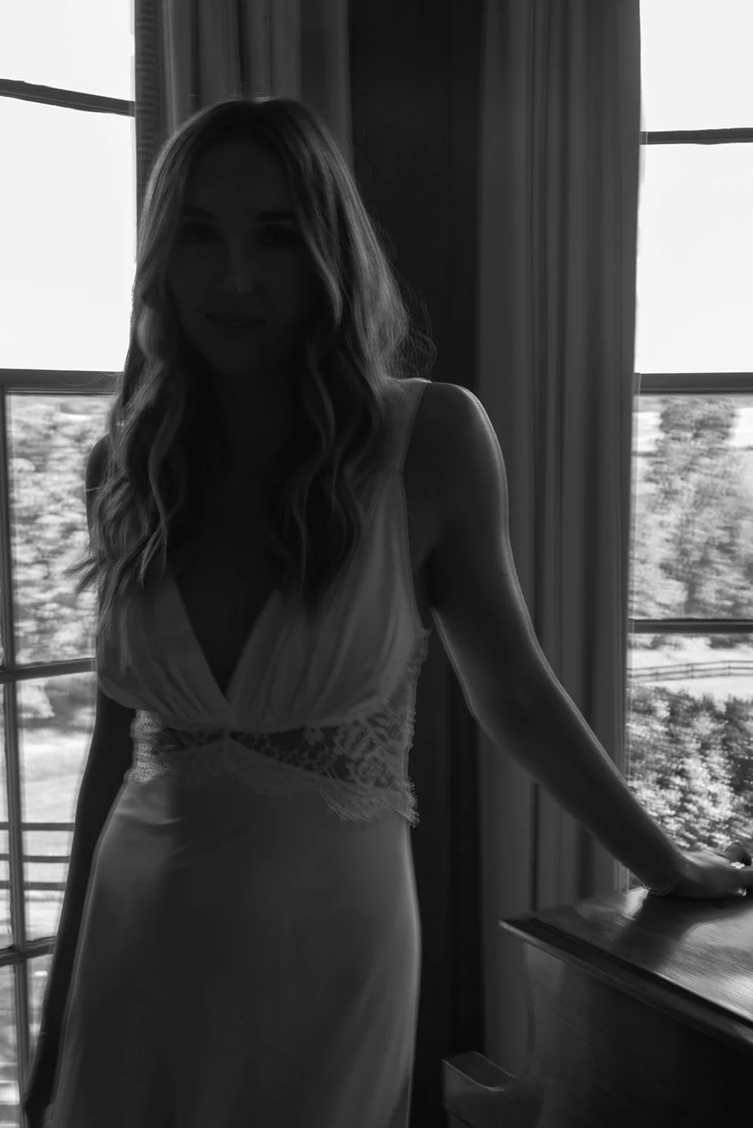 Black-and-white portrait of the bride seated beside a window during wedding-day preparations at Goodstone Inn.