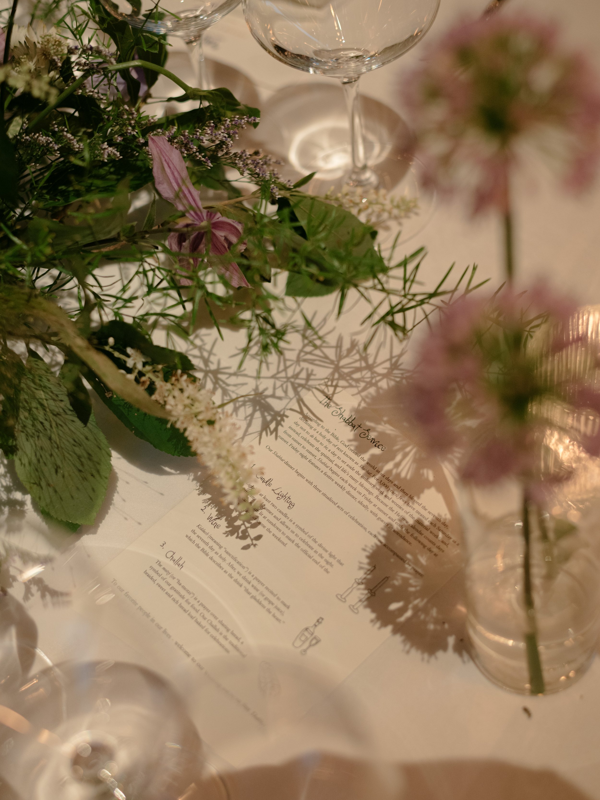 Floral, stationery, and place-setting details from the reception designed by Mudari Creative.