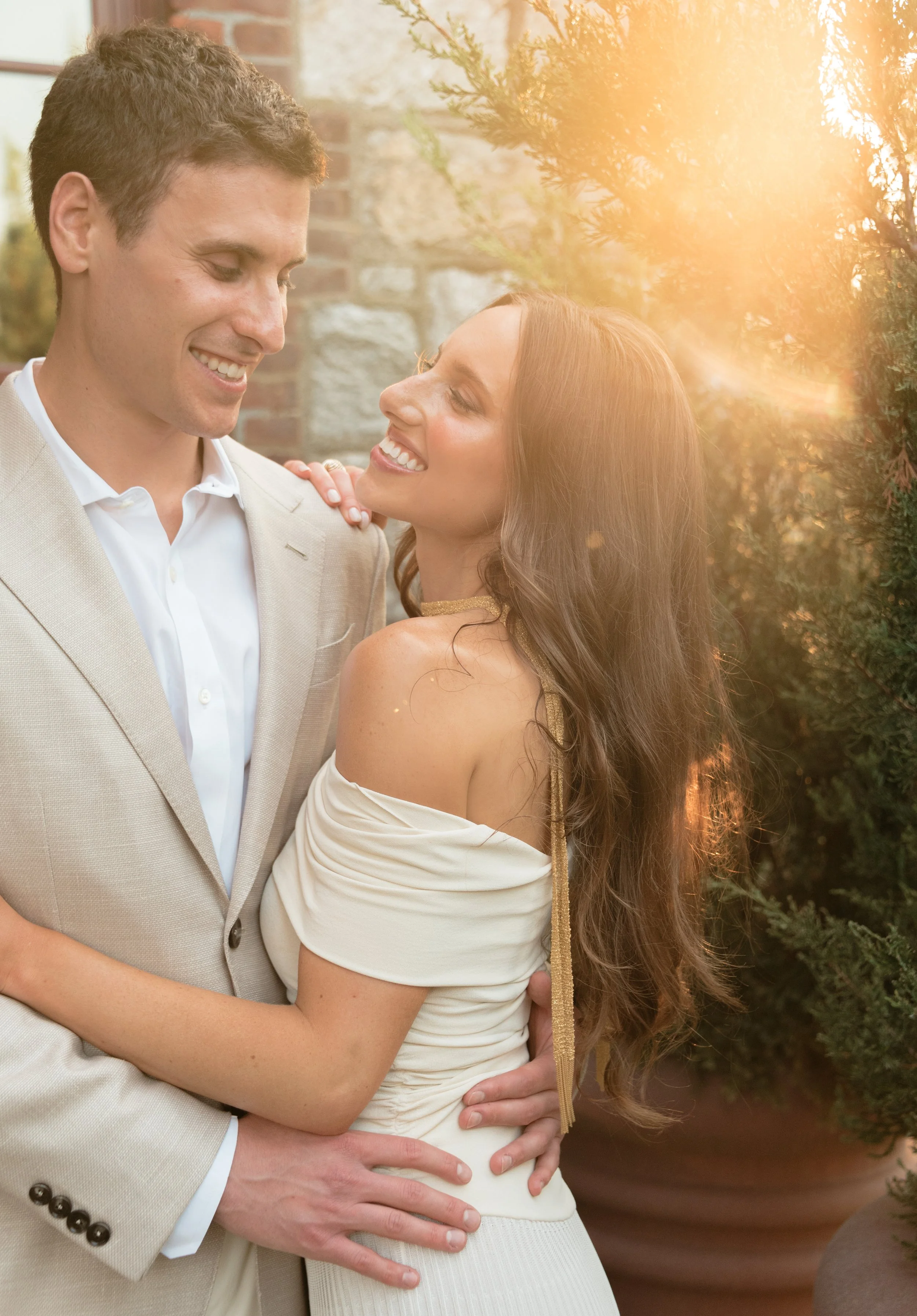 Sunlit portrait of bride and groom together outside The Abbey Inn & Spa.