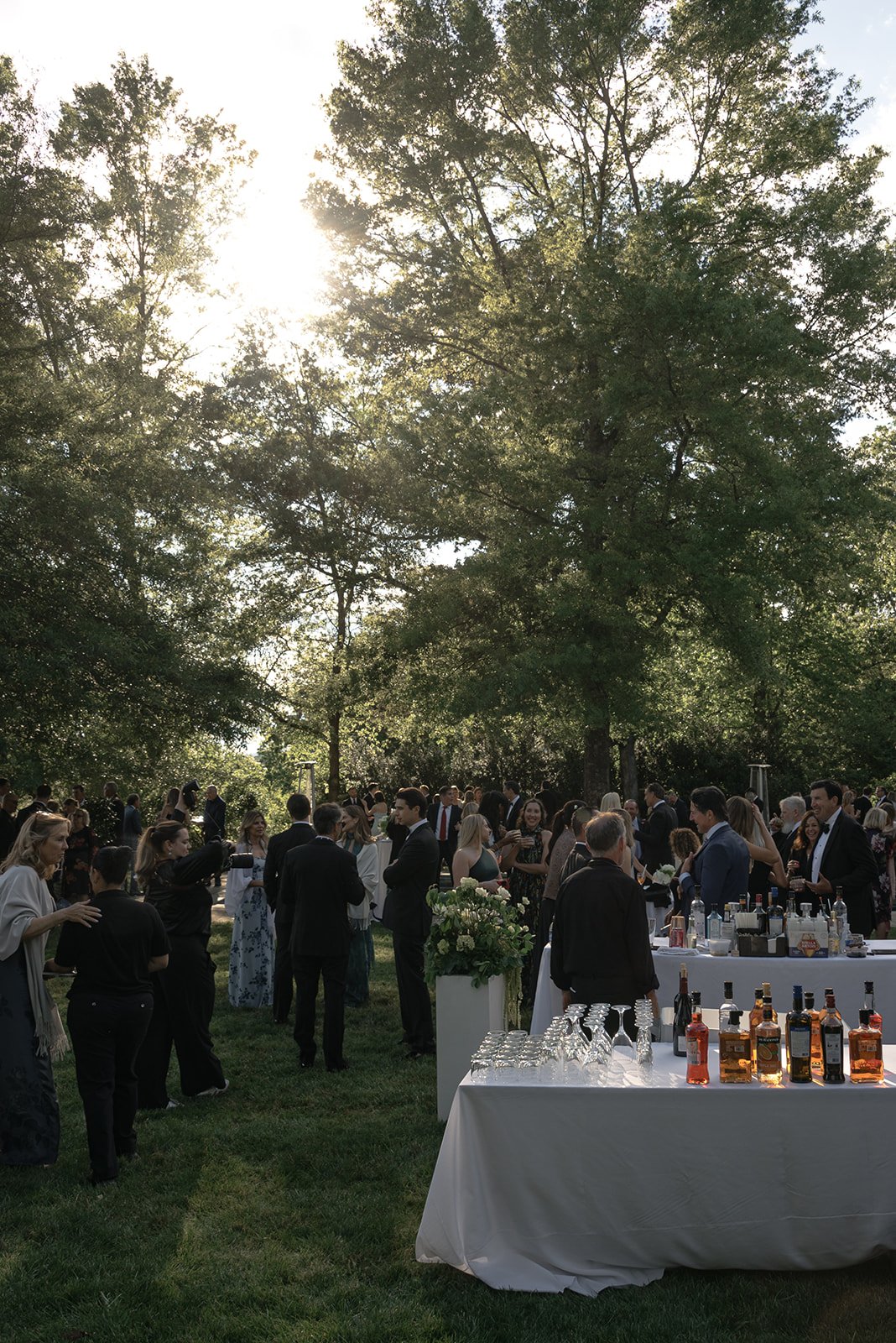 Outdoor cocktail hour setup surrounded by greenery and evening light at Goodstone Inn.
