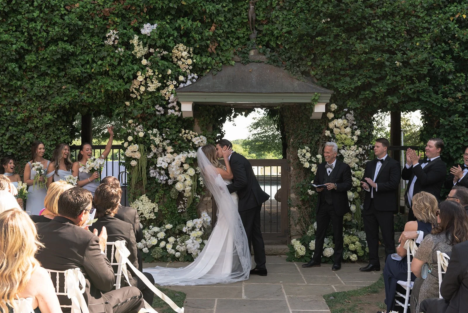 Bride and groom have their first kiss moment at the Ivy Wall at Goodstone Inn