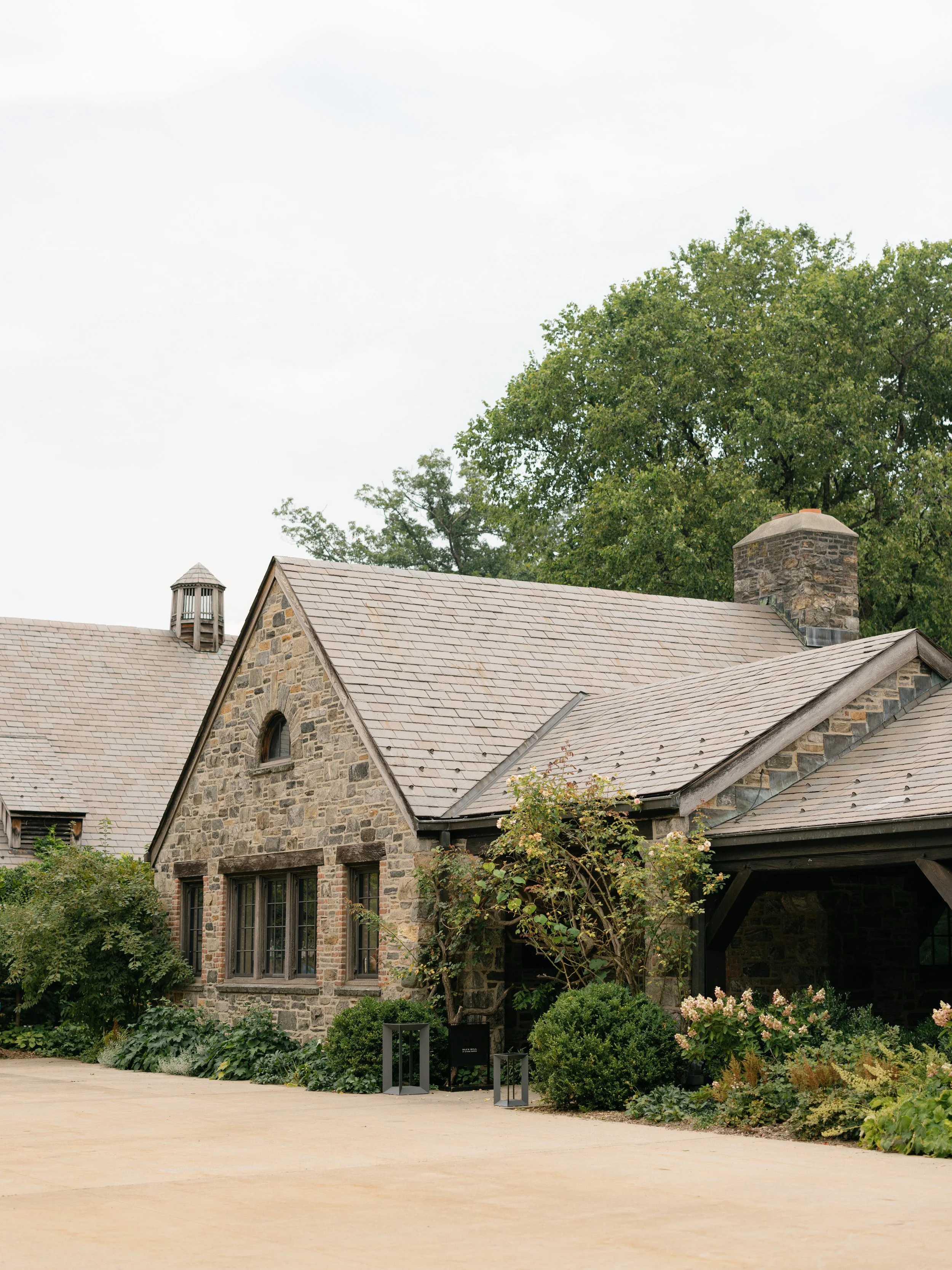 Garden pathways and historic architecture at Blue Hill at Stone Barns before a summer wedding celebration.