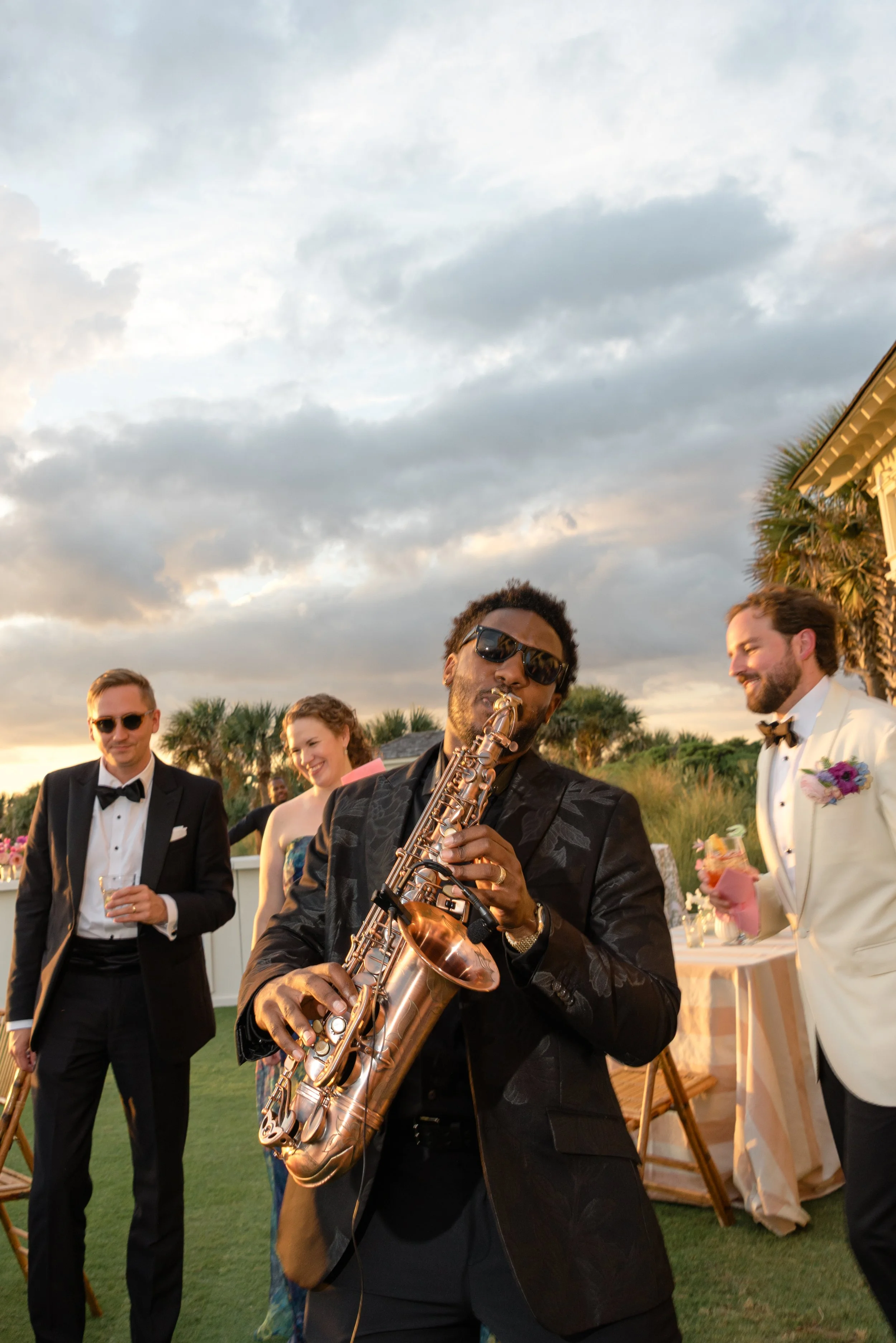 Saxophonist performs among guests during the outdoor cocktail hour at The Ocean Course on Kiawah Island.