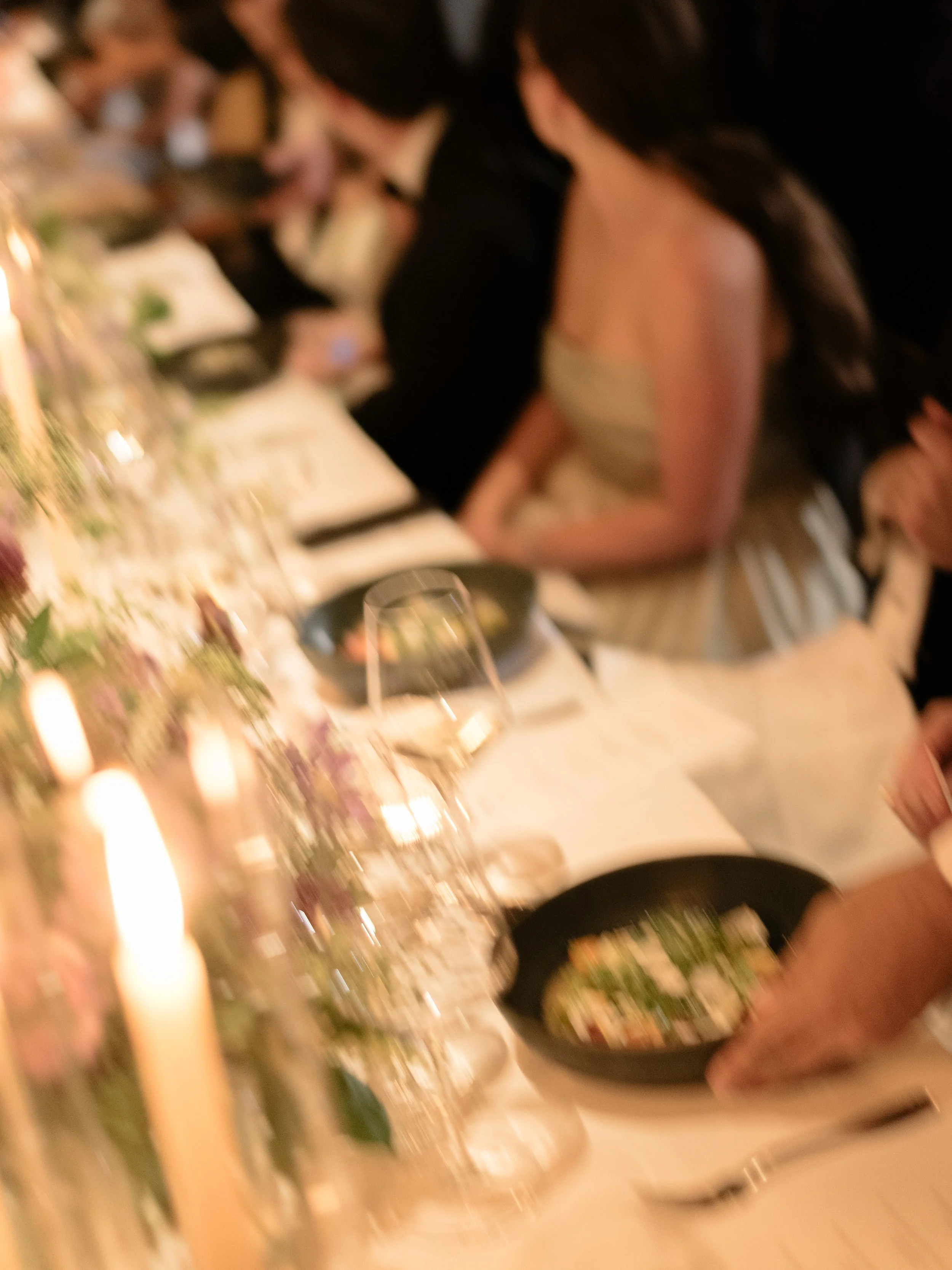 Guest dining beside glowing candles during the seasonal wedding meal at Blue Hill at Stone Barns.