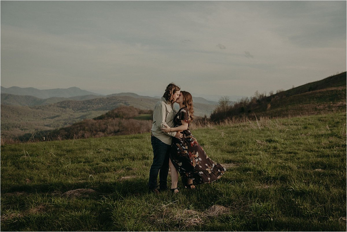 The bride wore a black floral free-flowing gown at her mountain love story session