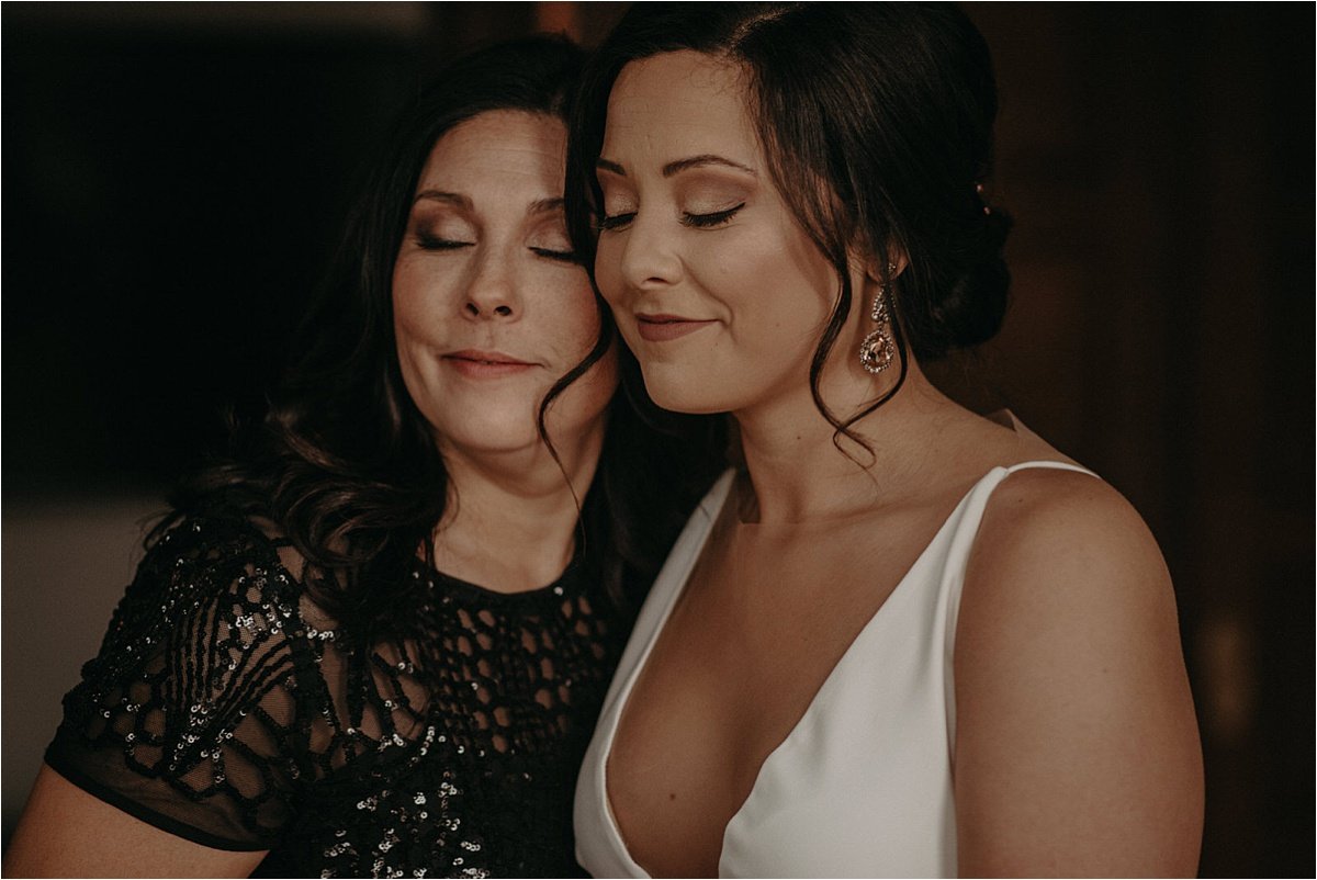 The bride and her mother share an embrace after seeing her in her wedding gown