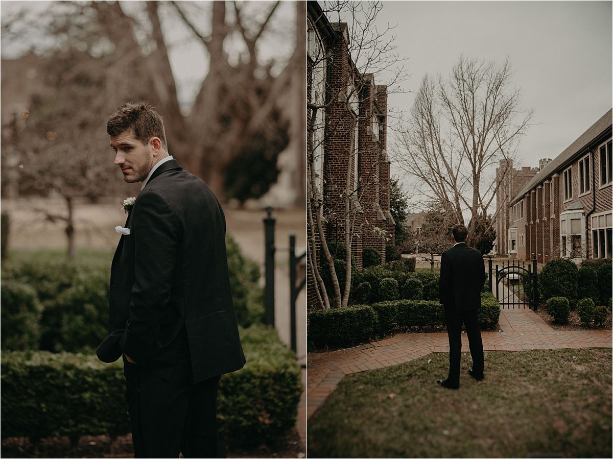 The groom waits for the first look with his bride in the gardens of Patten Chapel