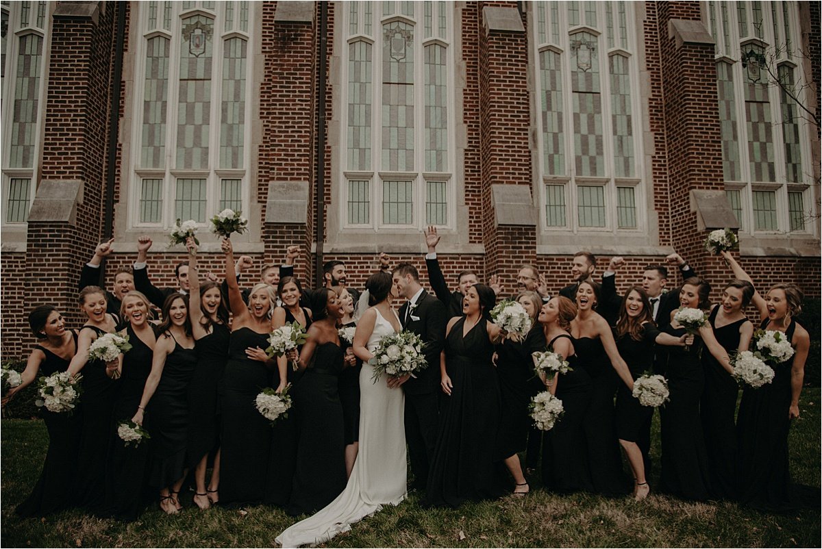 The wedding party celebrates the love of the bride and groom outside of Patten Chapel