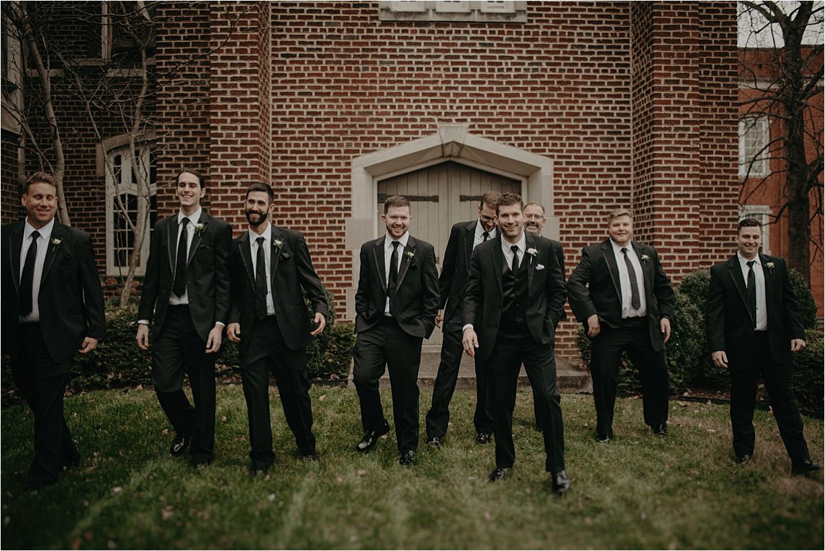 The groom and groomsmen dressed in black tie tuxes for this contemporary winter wedding