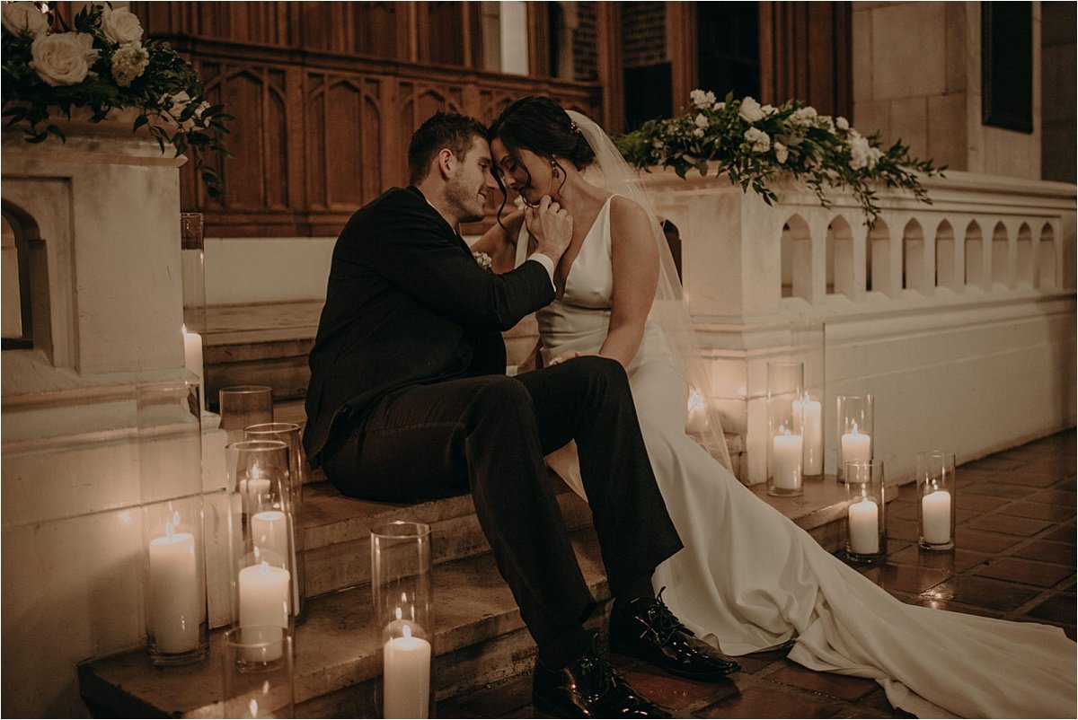 Romantic moments between the bride and groom on the steps of the altar of the church 