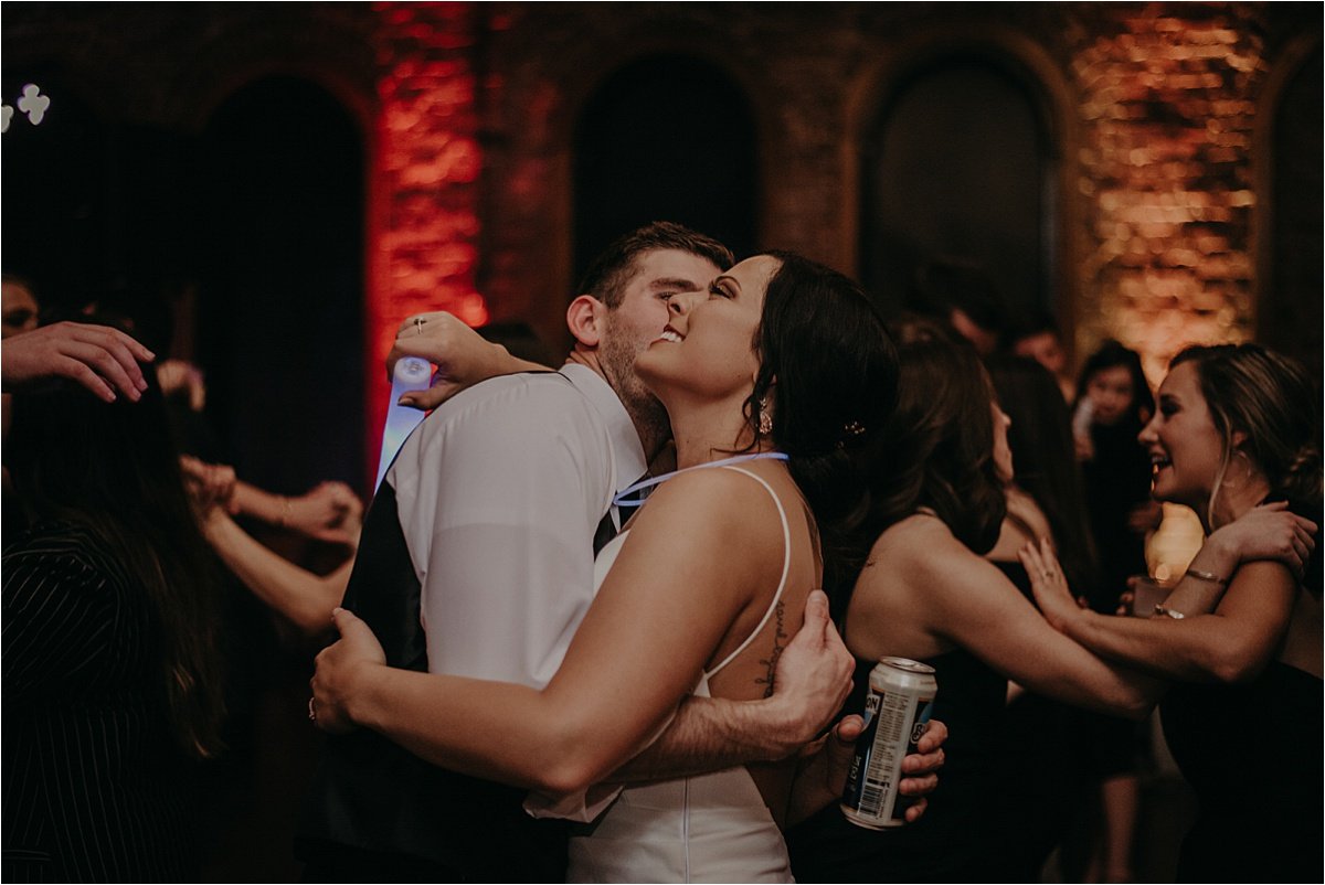 The bride and groom embrace during the party