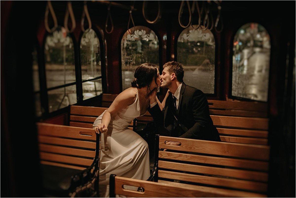 The bride and groom ride around in Chattanooga's trolley for late night rainy portraits after their wedding reception