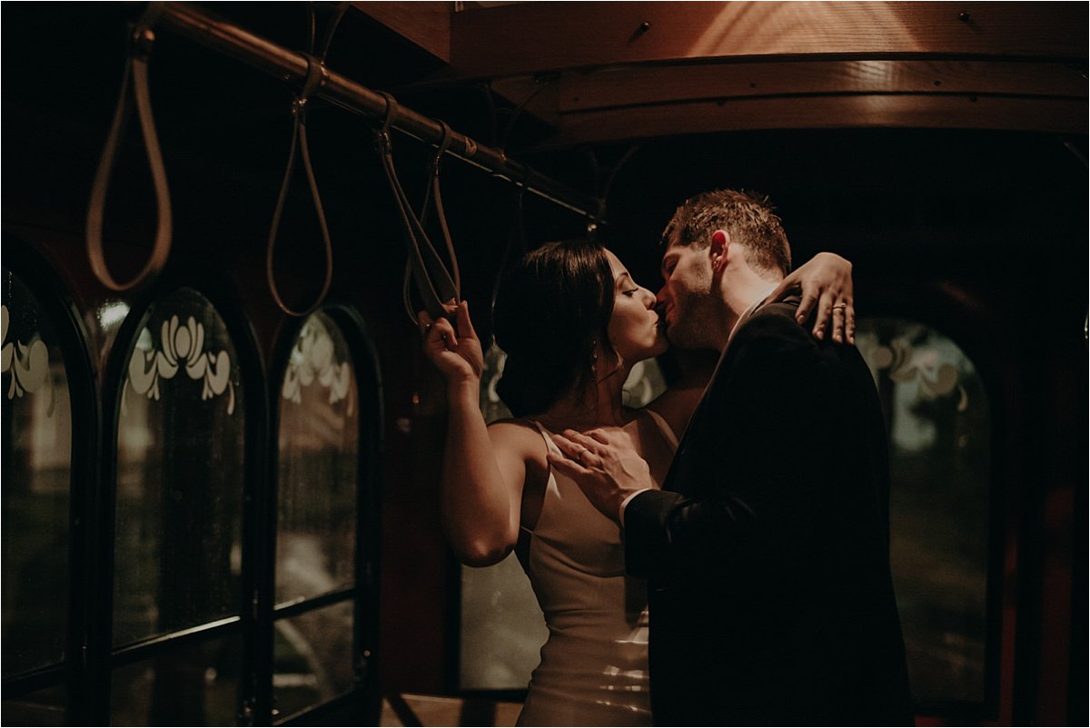 Sharing a kiss in Chattanooga, TN's trolley on a rainy wedding night