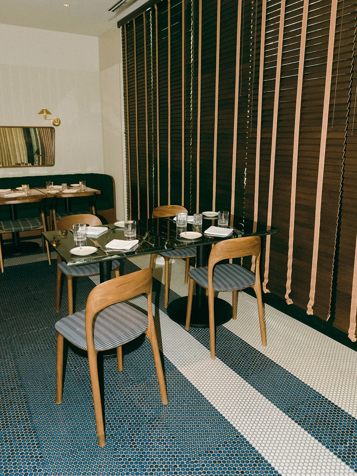 Editorial hospitality photograph of a restaurant interior featuring modern furnishings, architectural details, and a thoughtfully designed dining atmosphere.