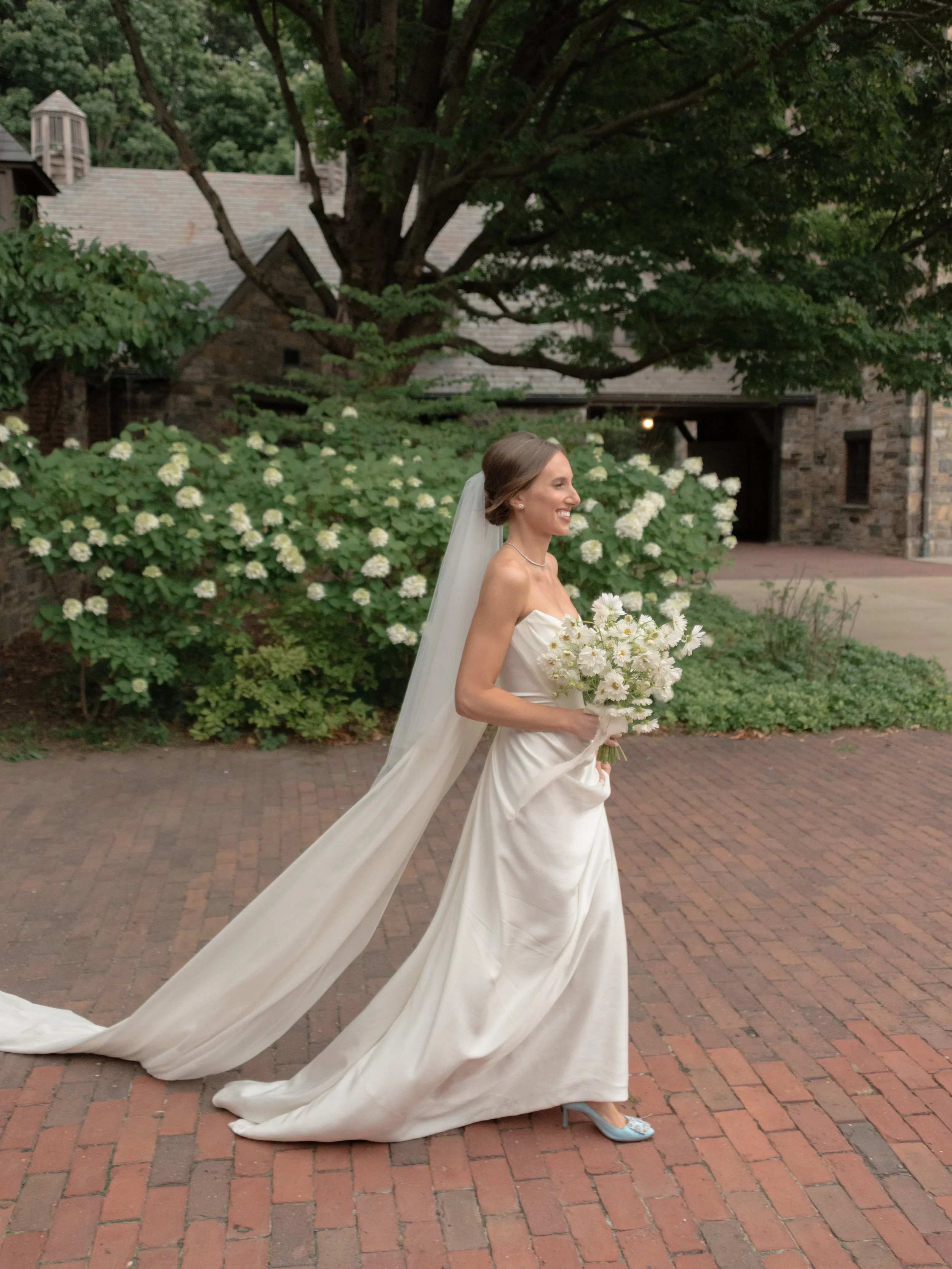 Bride walking through the gardens of Blue Hill at Stone Barns wearing a dramatic wedding veil.