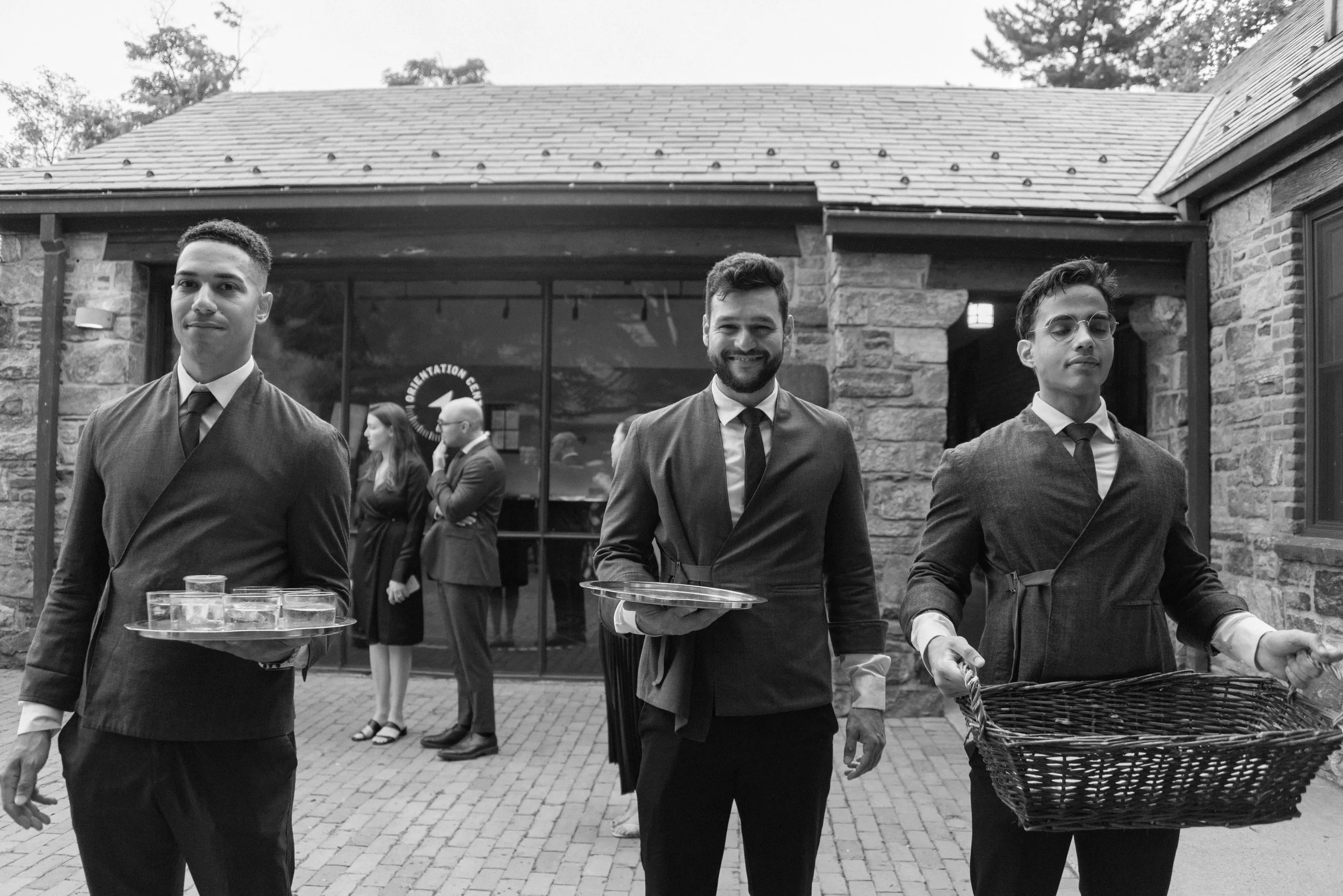 Hospitality managers at Blue Hill at Stone Barns pass out lemongrass shots and hot towels to guests upon arrival to the wedding. 