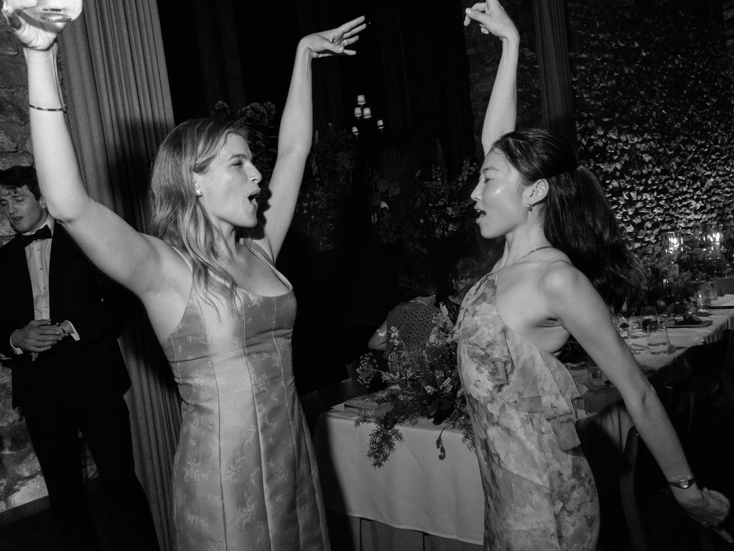 Black-and-white photograph of women dancing together during the late-night wedding celebration at Blue Hill at Stone Barns.