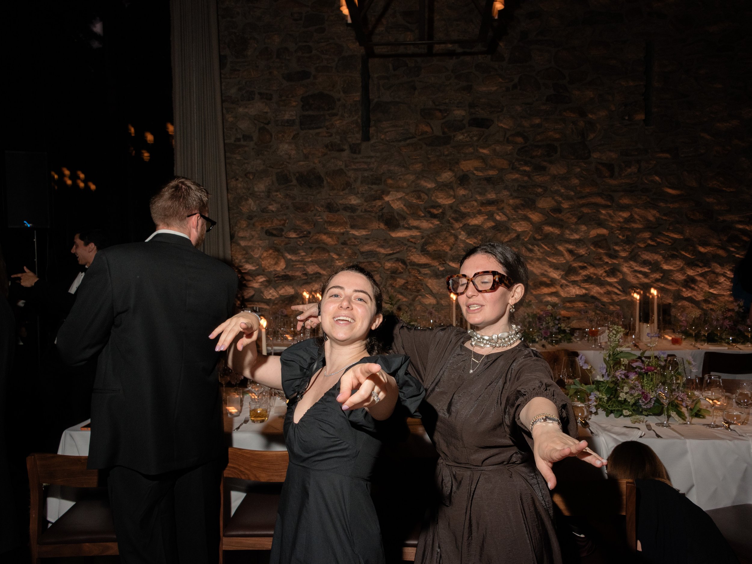 The Mudari Creative planners and designers, Olivia and Taylor, enjoy the wedding reception they designed and planned at Blue Hill at Stone Barns. 