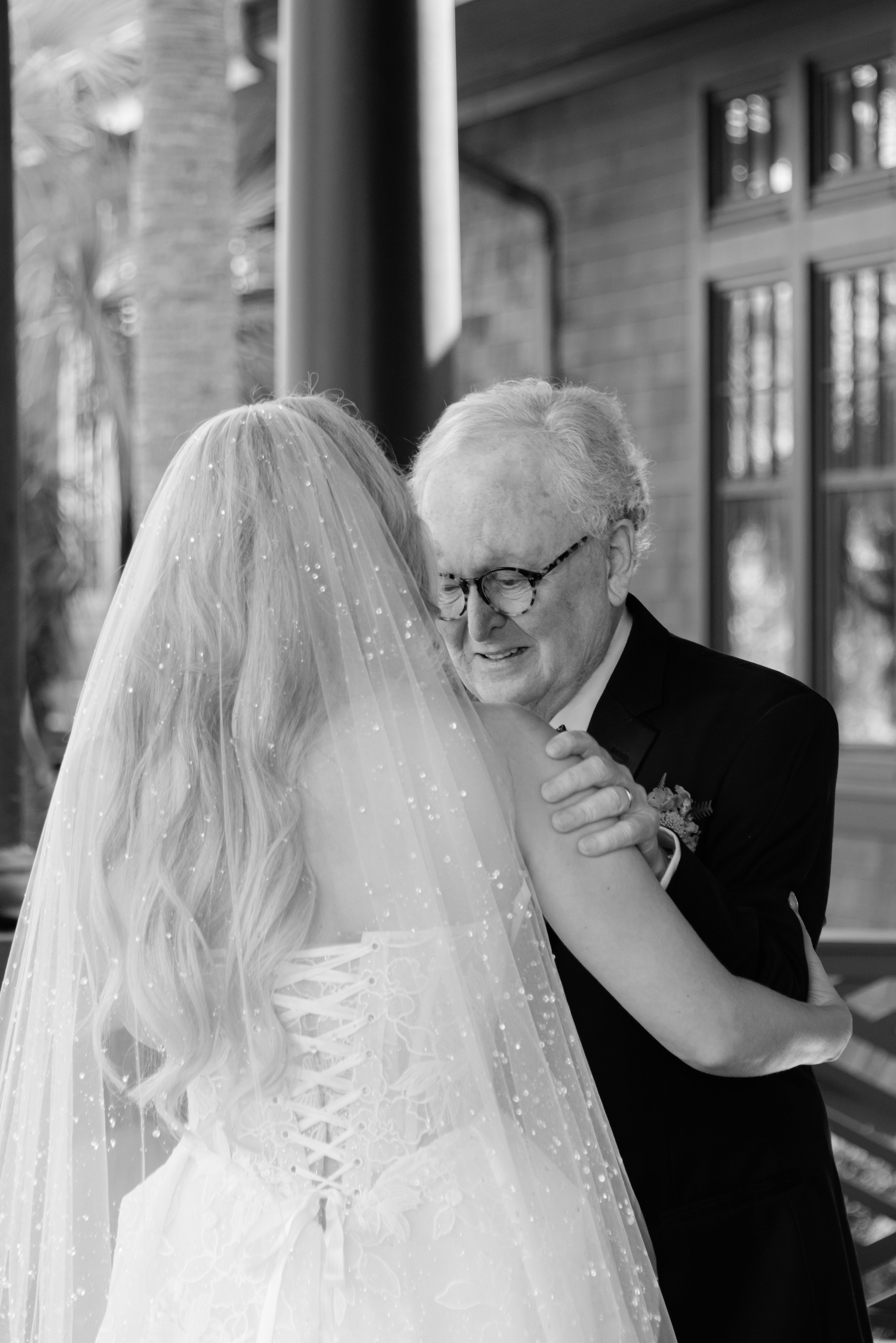 Katie embraces her father during an emotional first look at the private estate before the wedding ceremony.