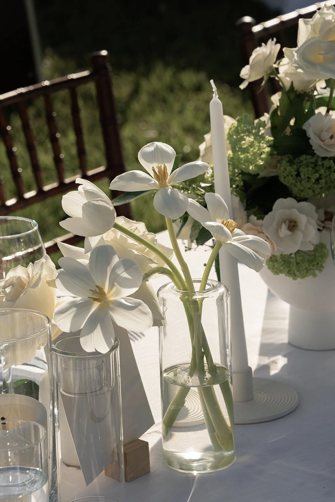 White flower stems arranged in a clear glass vase beside a table number at Goodstone Inn.