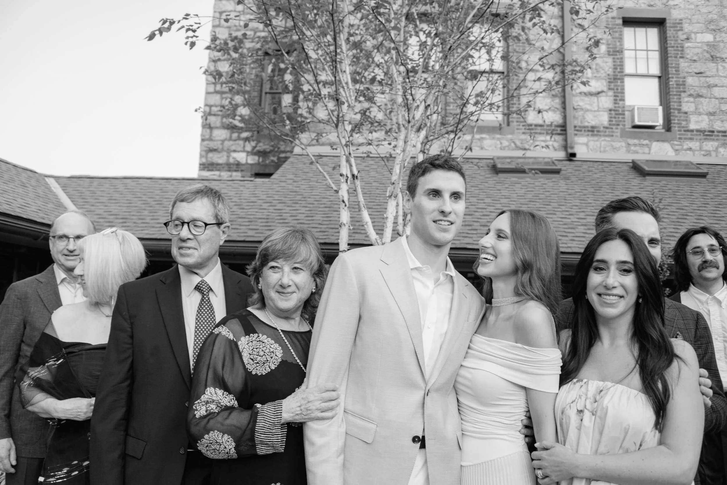 Black-and-white family portrait with Jennie and Will during their wedding weekend rehearsal dinner.