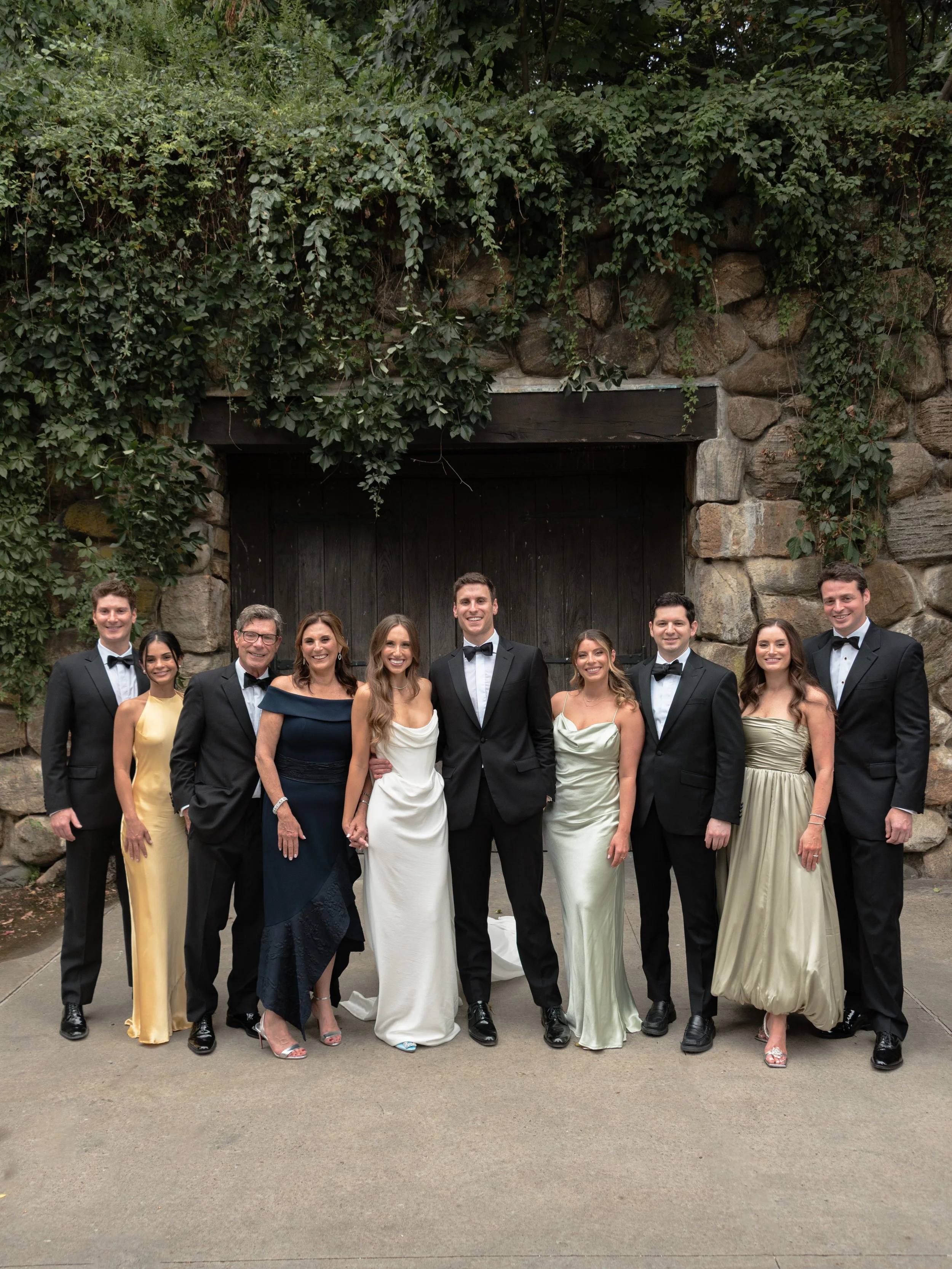 Jennie and Will gather with their extended family for a large wedding portrait outside Blue Hill at Stone Barns.
