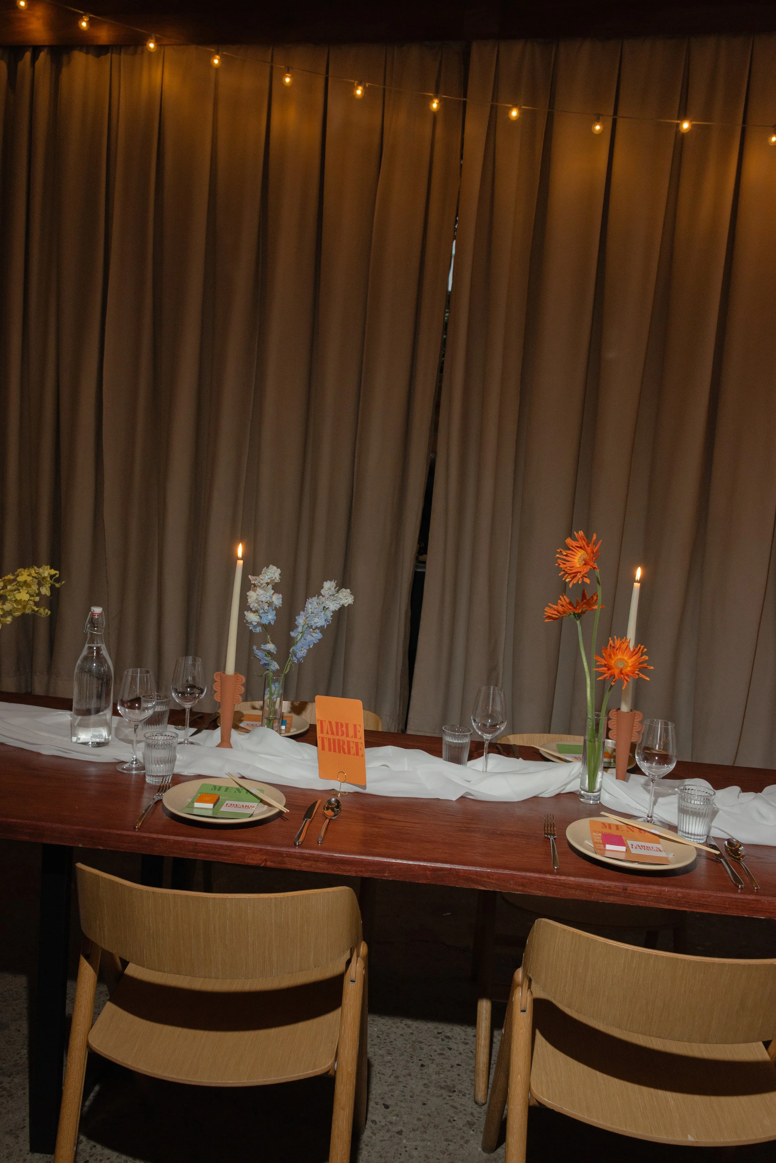 Intimate wedding reception tablescape featuring candles, floral arrangements, and intentional design details at Rule of Thirds in Brooklyn, New York.