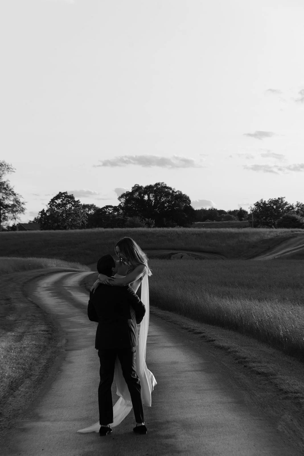 Black-and-white bride and groom portrait in the open road at Goodstone Inn.
