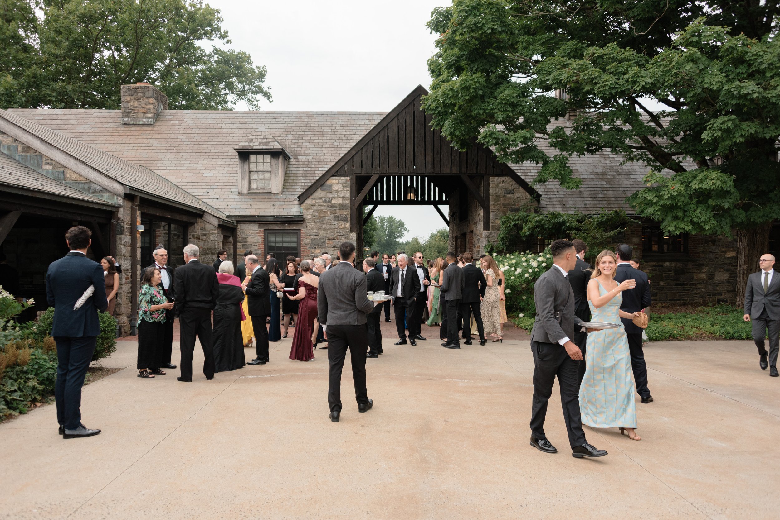 Guests mingle in the courtyard at Blue Hill at Stone Barns before the ceremony for passed champagne, lemongrass shots, and hot towels. 