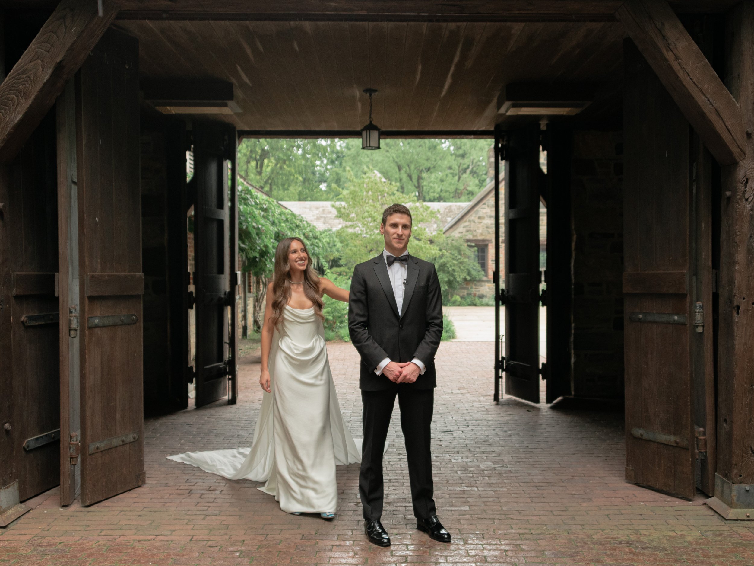 Couple sharing their first look beneath the historic architecture of Blue Hill at Stone Barns.
