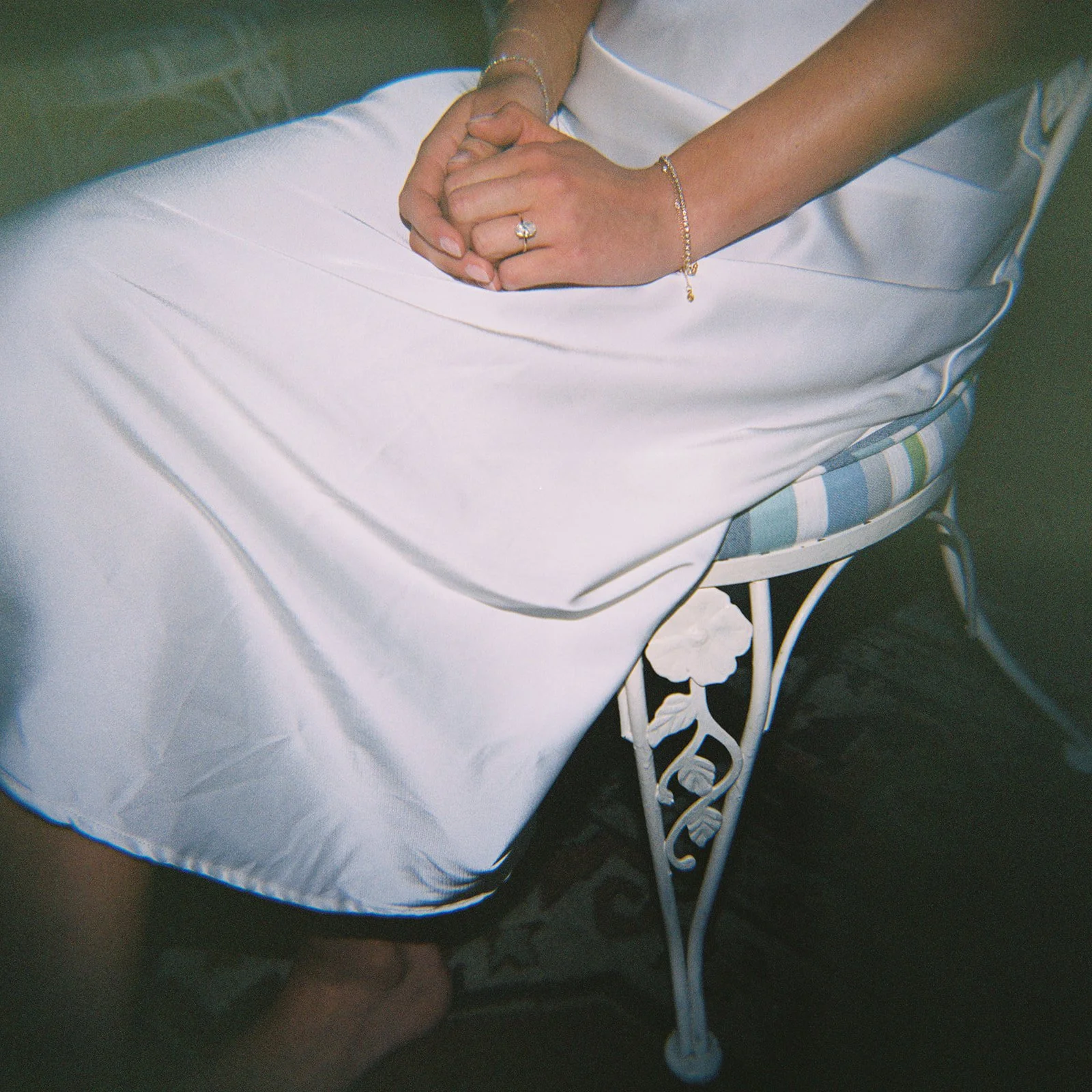 Holga photo close-up of the bride’s hand resting on pale fabric during preparations at Goodstone Inn.