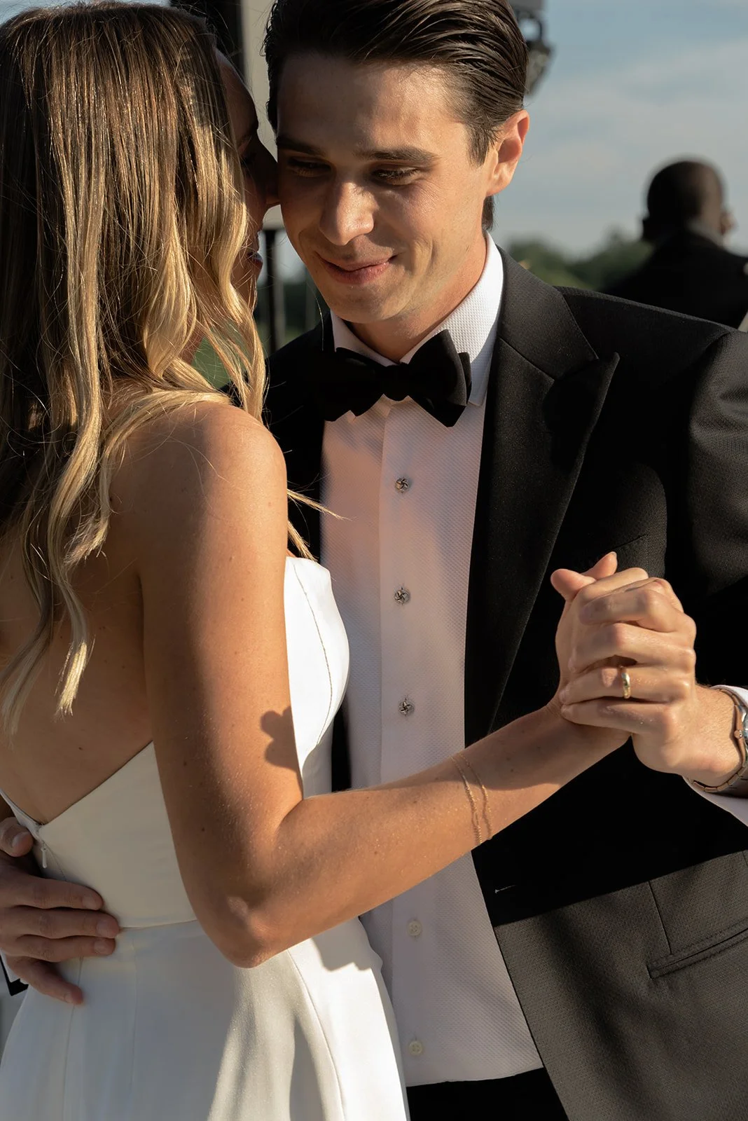 Close-up of the bride and groom holding hands while dancing at their Goodstone Inn wedding.