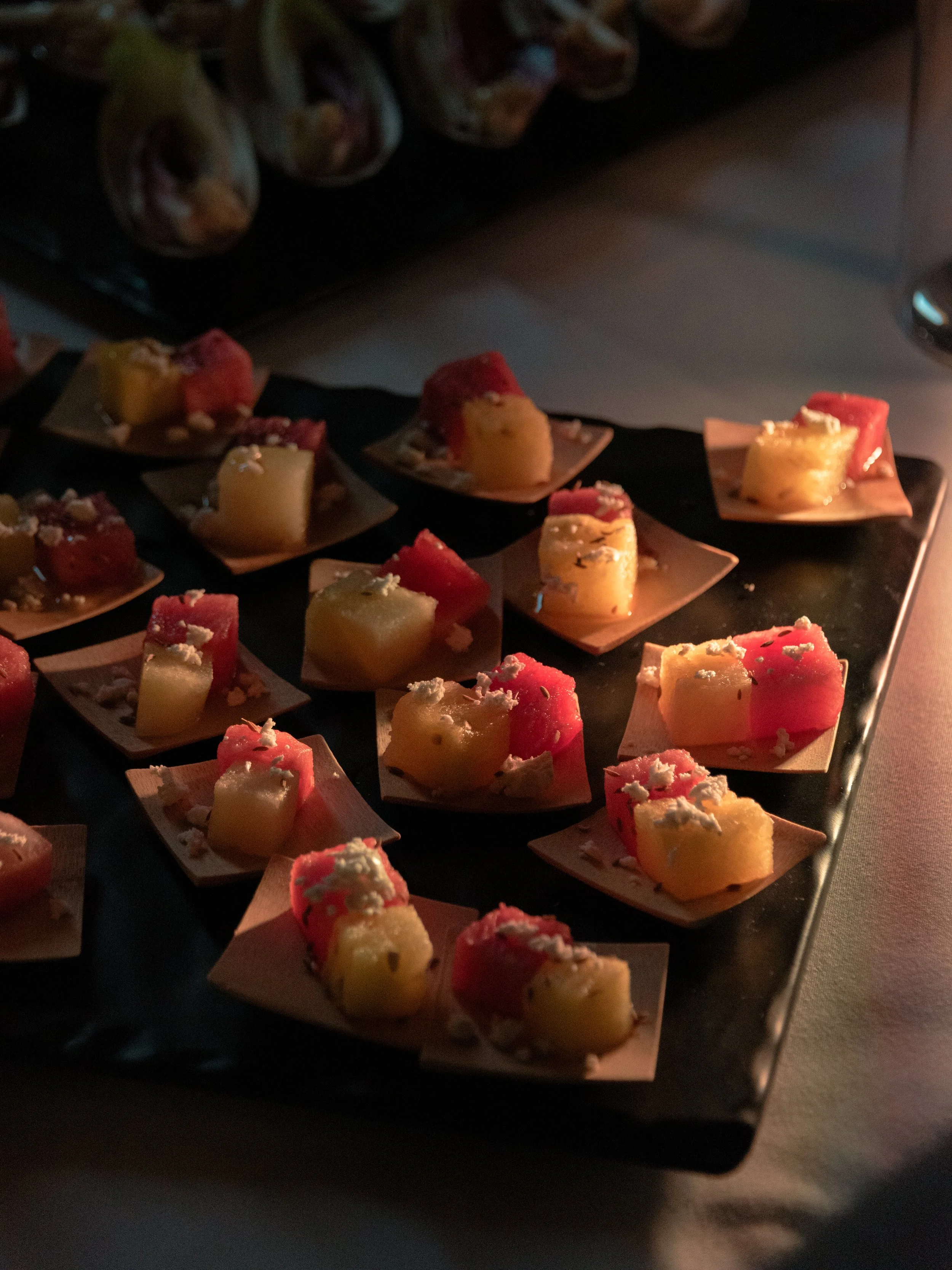 Colorful passed appetizers prepared for guests at the rehearsal dinner.