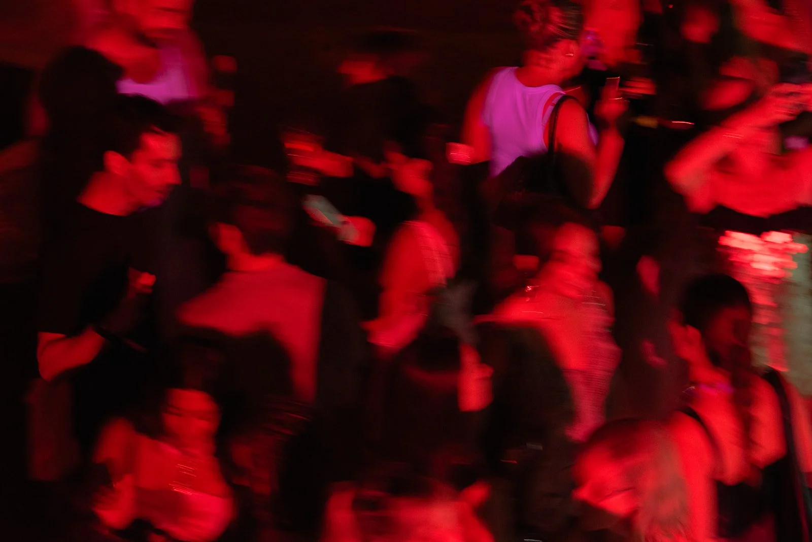 Editorial event photograph of guests dancing at the Cannes Lions 2026 house party, captured with motion blur and red lighting to reflect the energy and atmosphere of the evening.