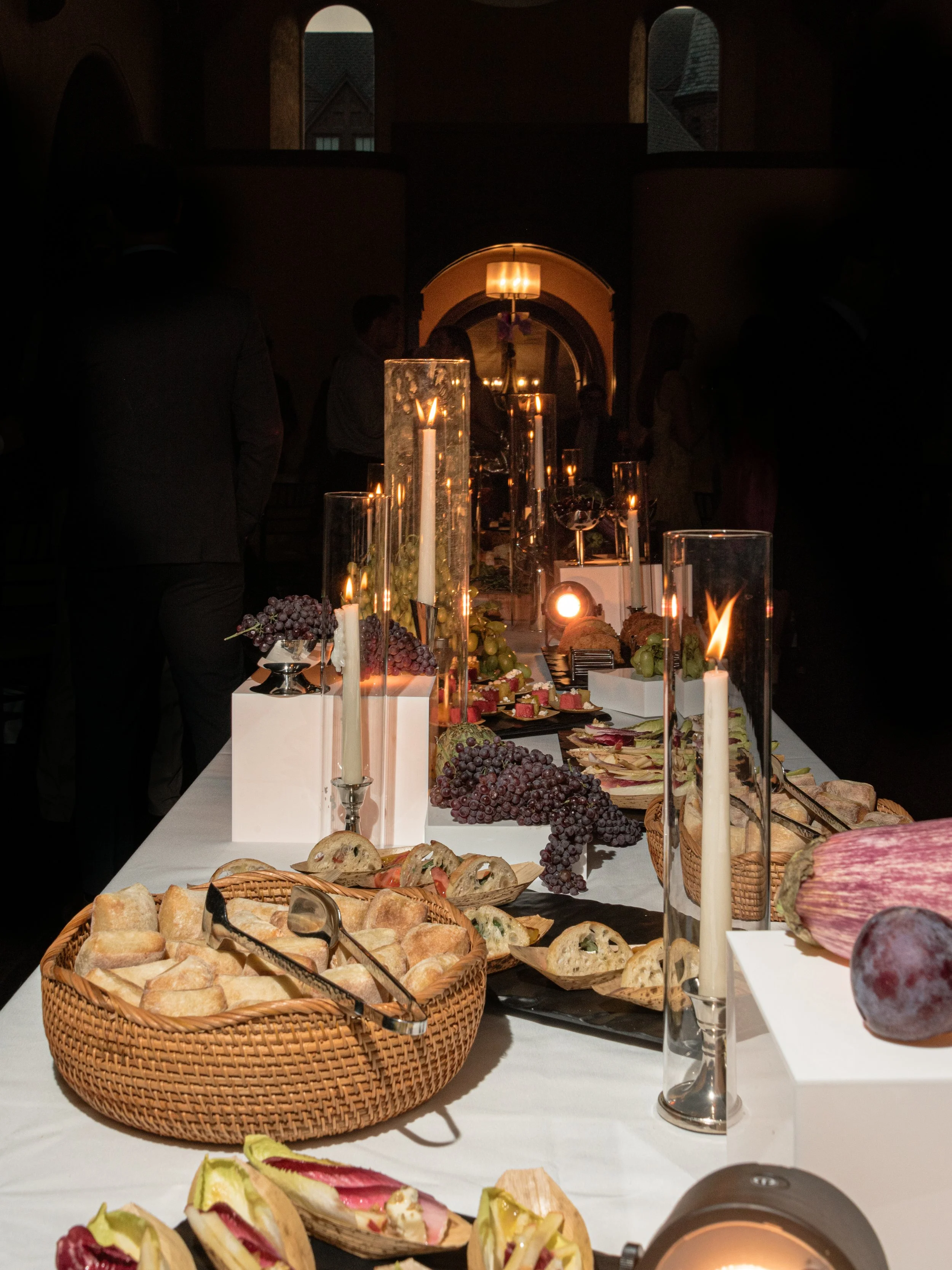 Candlelit buffet of bread, produce and passed bites at The Abbey Inn & Spa rehearsal dinner.