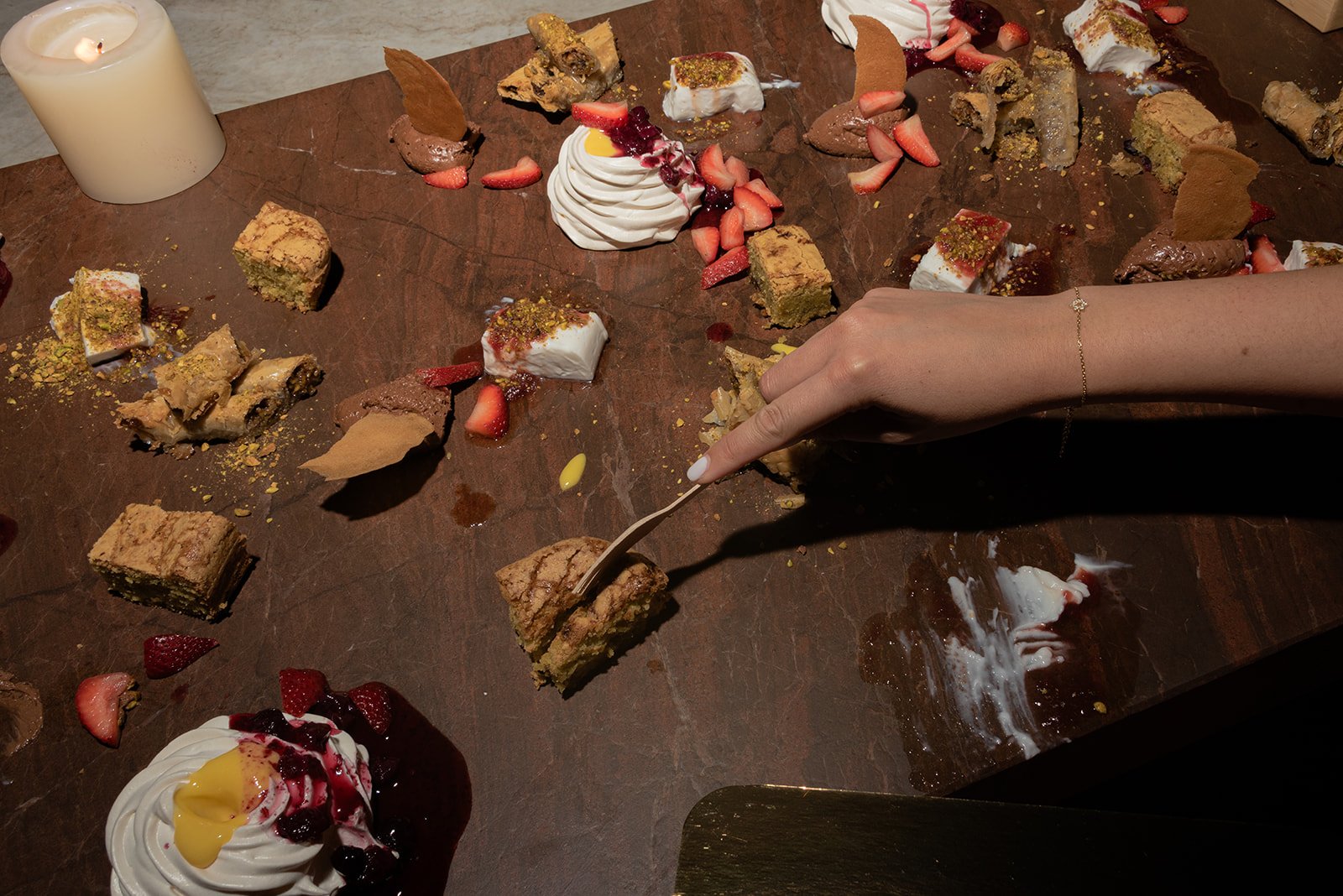 Close-up editorial photograph of guests enjoying an intimate, beautifully styled wedding dinner, creating an interactive experience and capturing the textures and atmosphere of the celebration at MALKA in West Palm Beach, Florida.