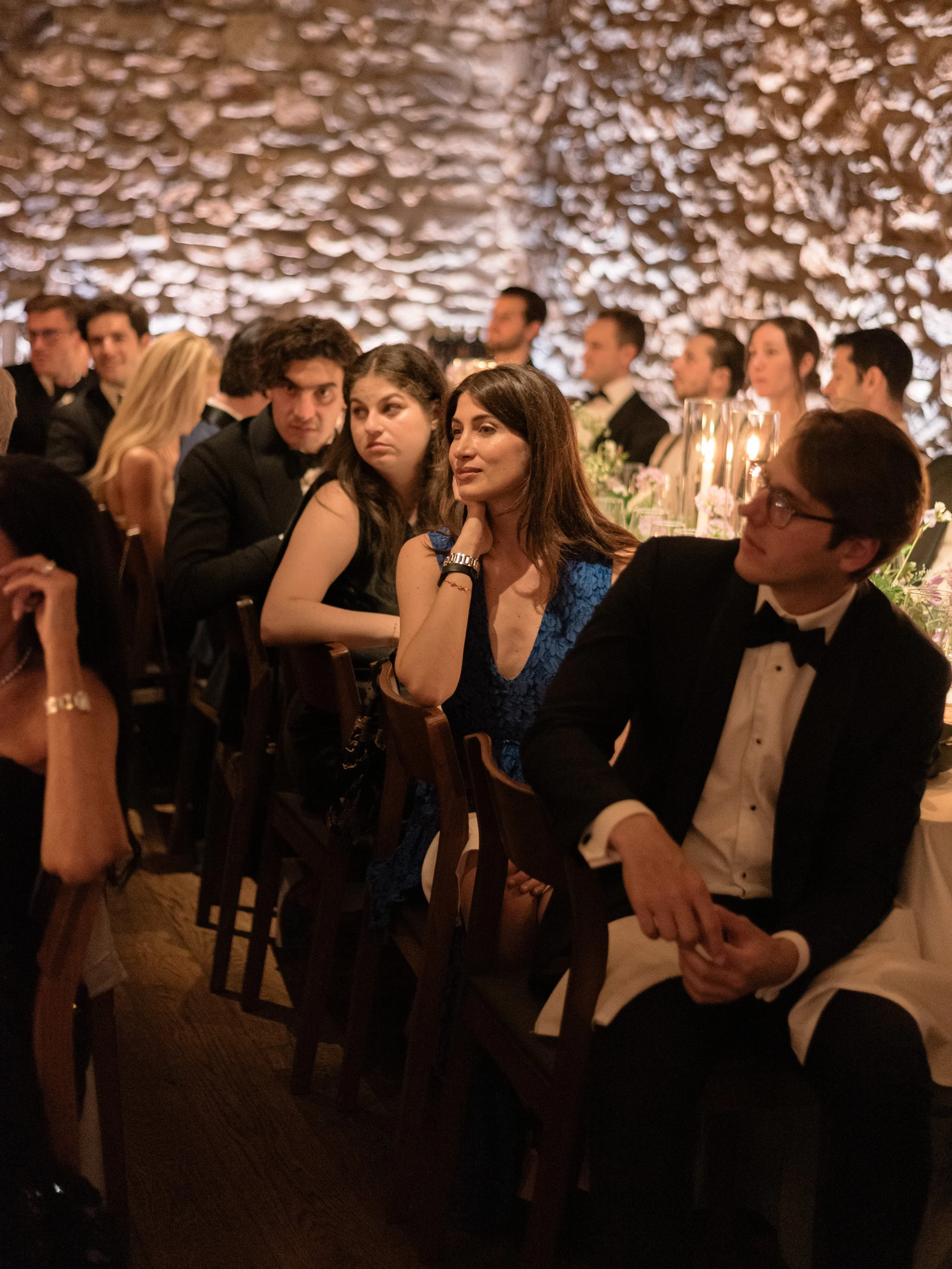 Guests listening attentively during reception speeches inside the stone dining room at Blue Hill at Stone Barns.
