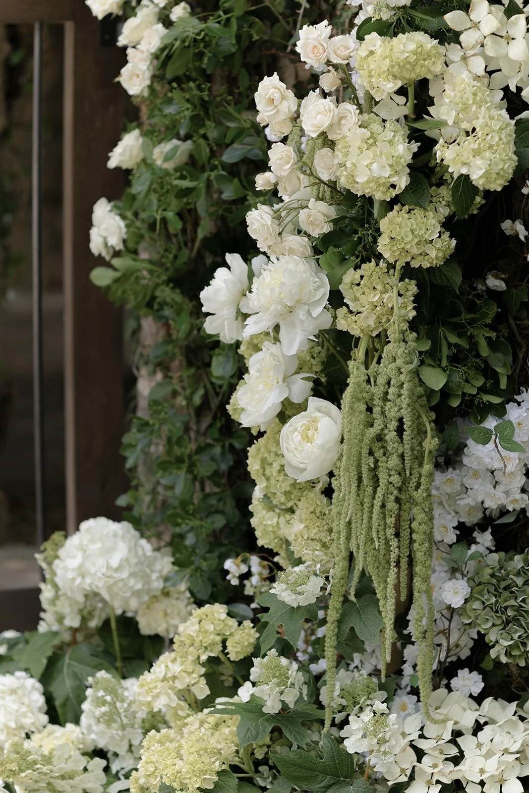 Abundant white and ivory wedding flowers with greenery arranged for a spring ceremony at Goodstone Inn.