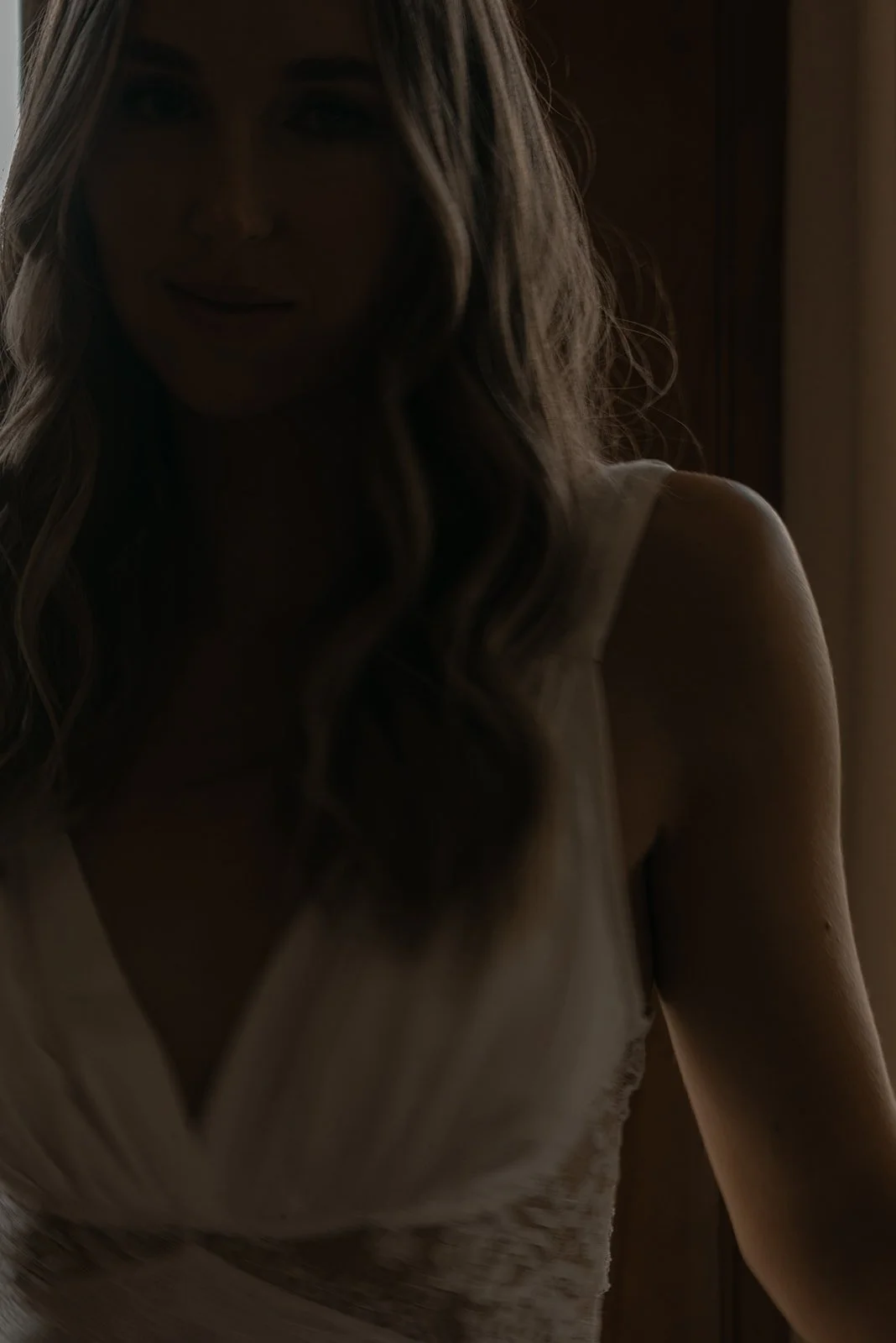 Soft close-up portrait of the bride reclining during wedding-day preparations at Goodstone Inn.