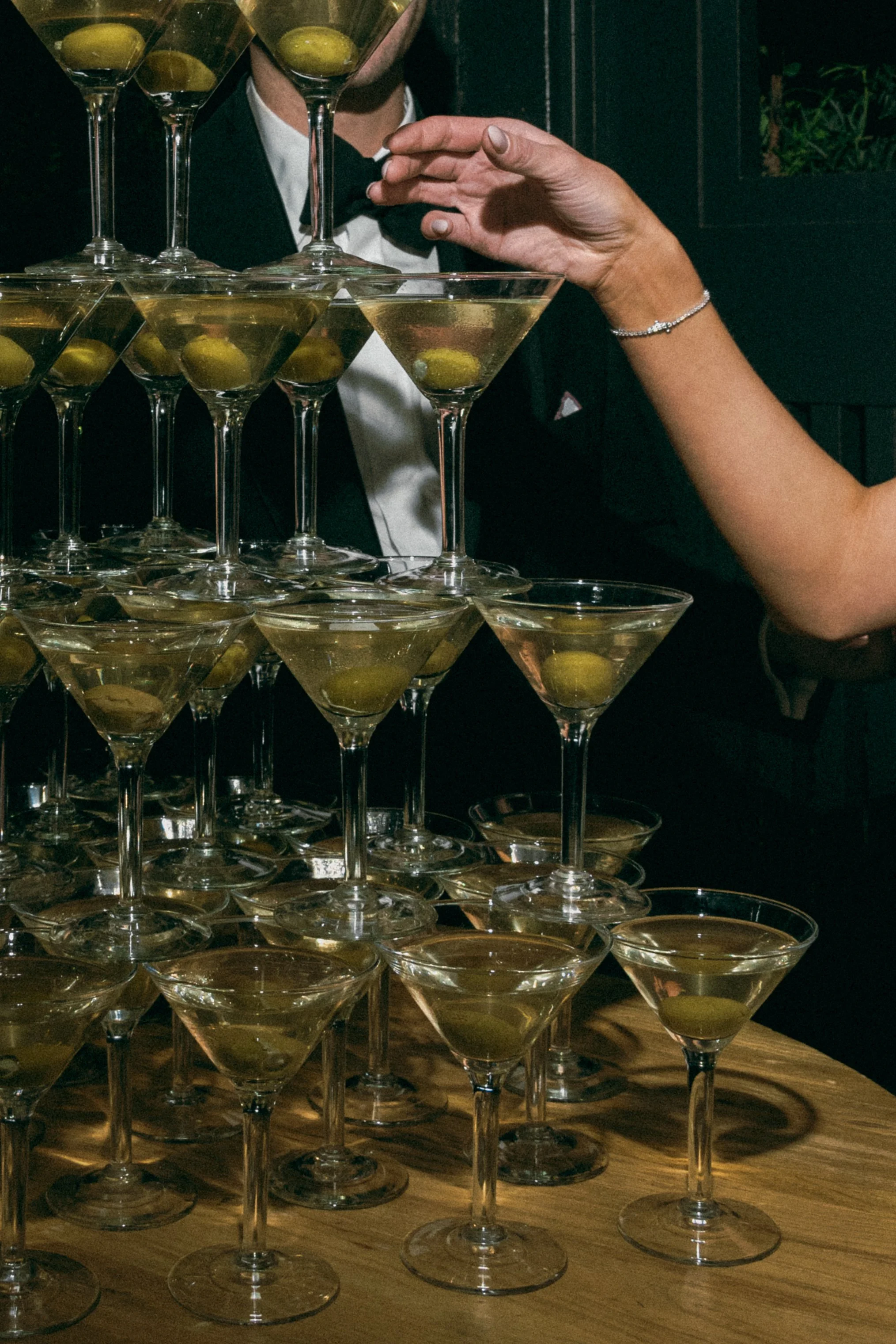 Tower of martini glasses photographed with direct flash during an elegant wedding reception at Gibbes Museum in Charleston, South Carolina