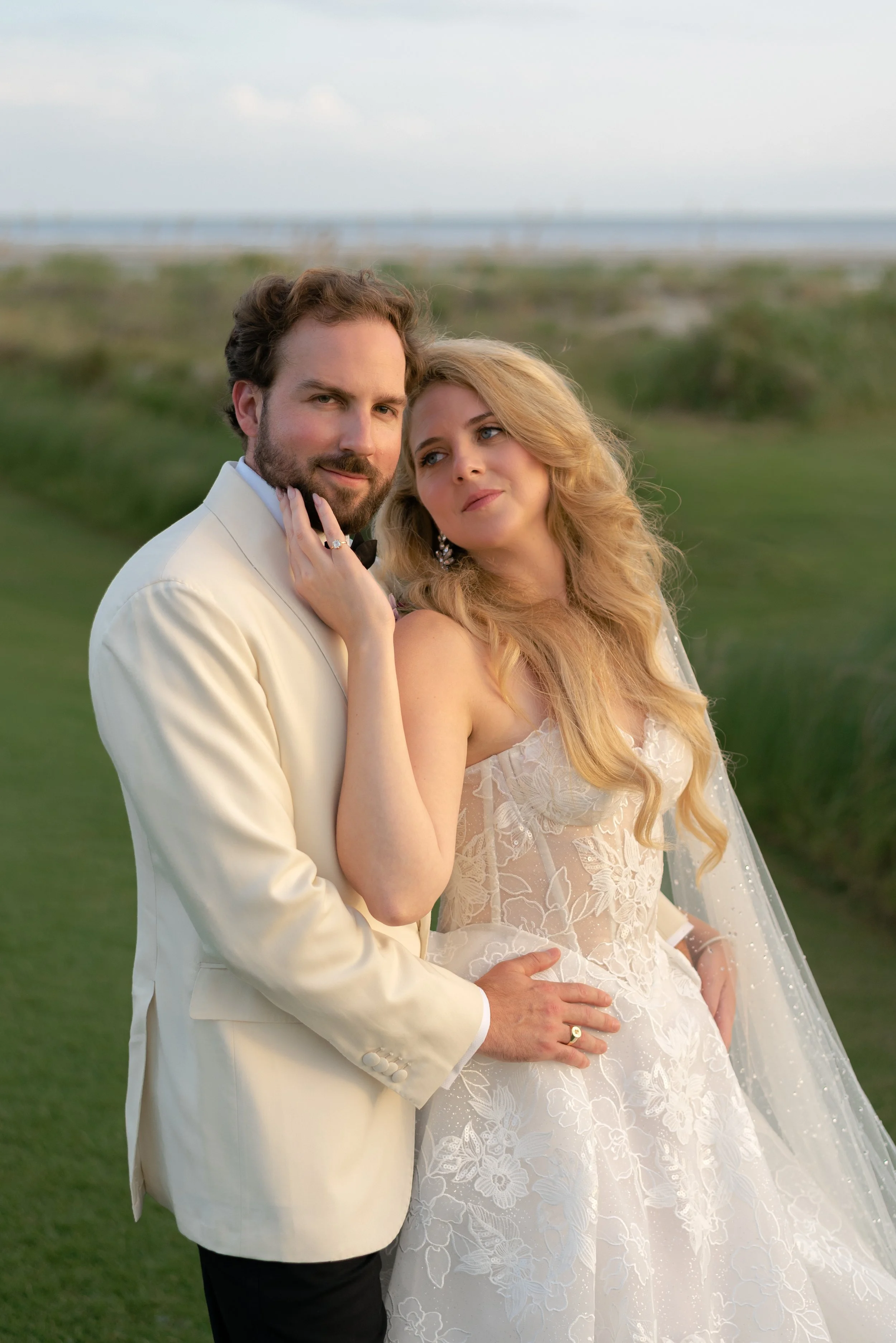 The bride and groom share a close portrait in the soft evening light after their Ocean Course ceremony.