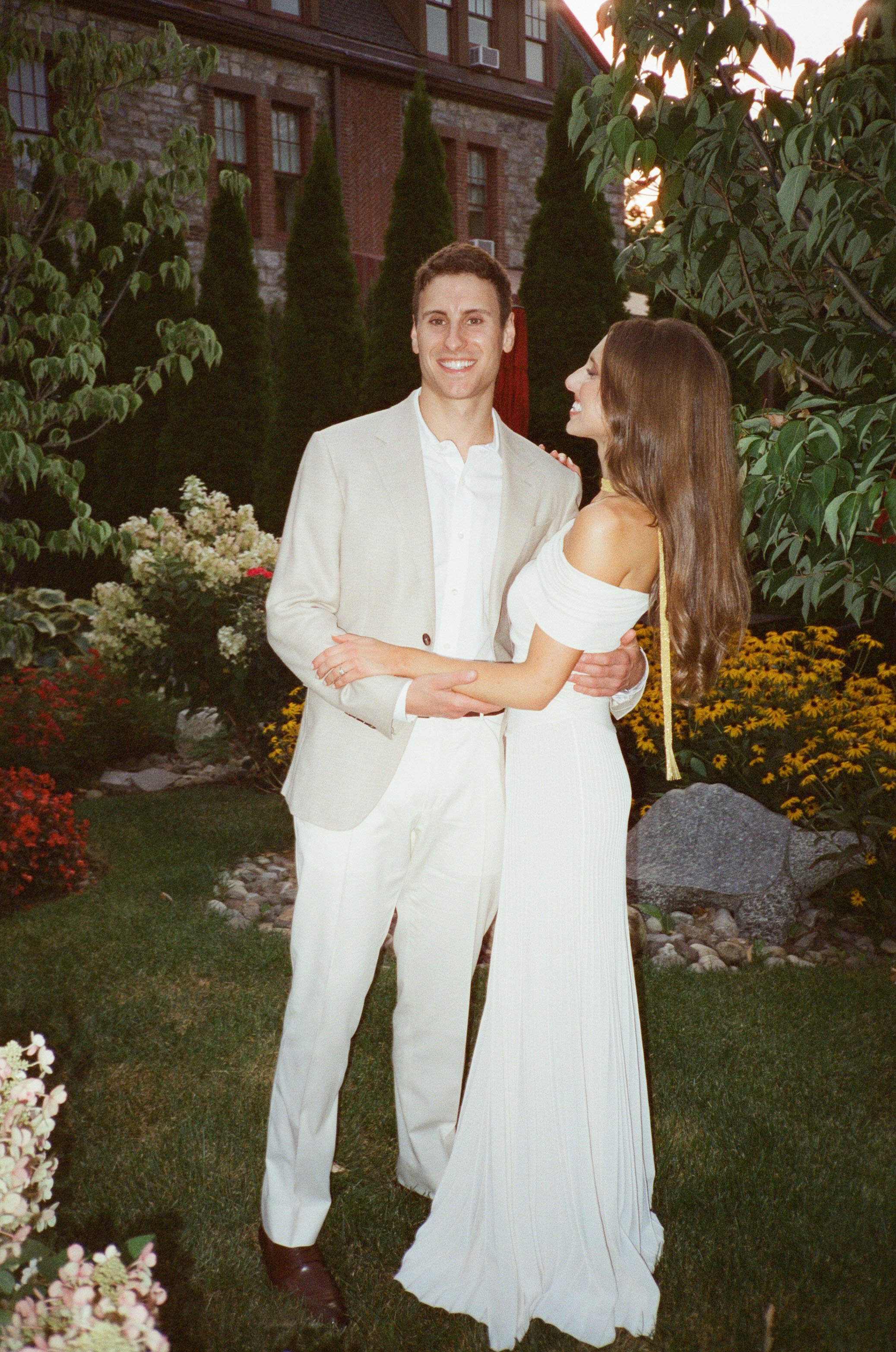 Jennie and Will pose together in coordinating white attire before their rehearsal dinner at The Abbey Inn & Spa.