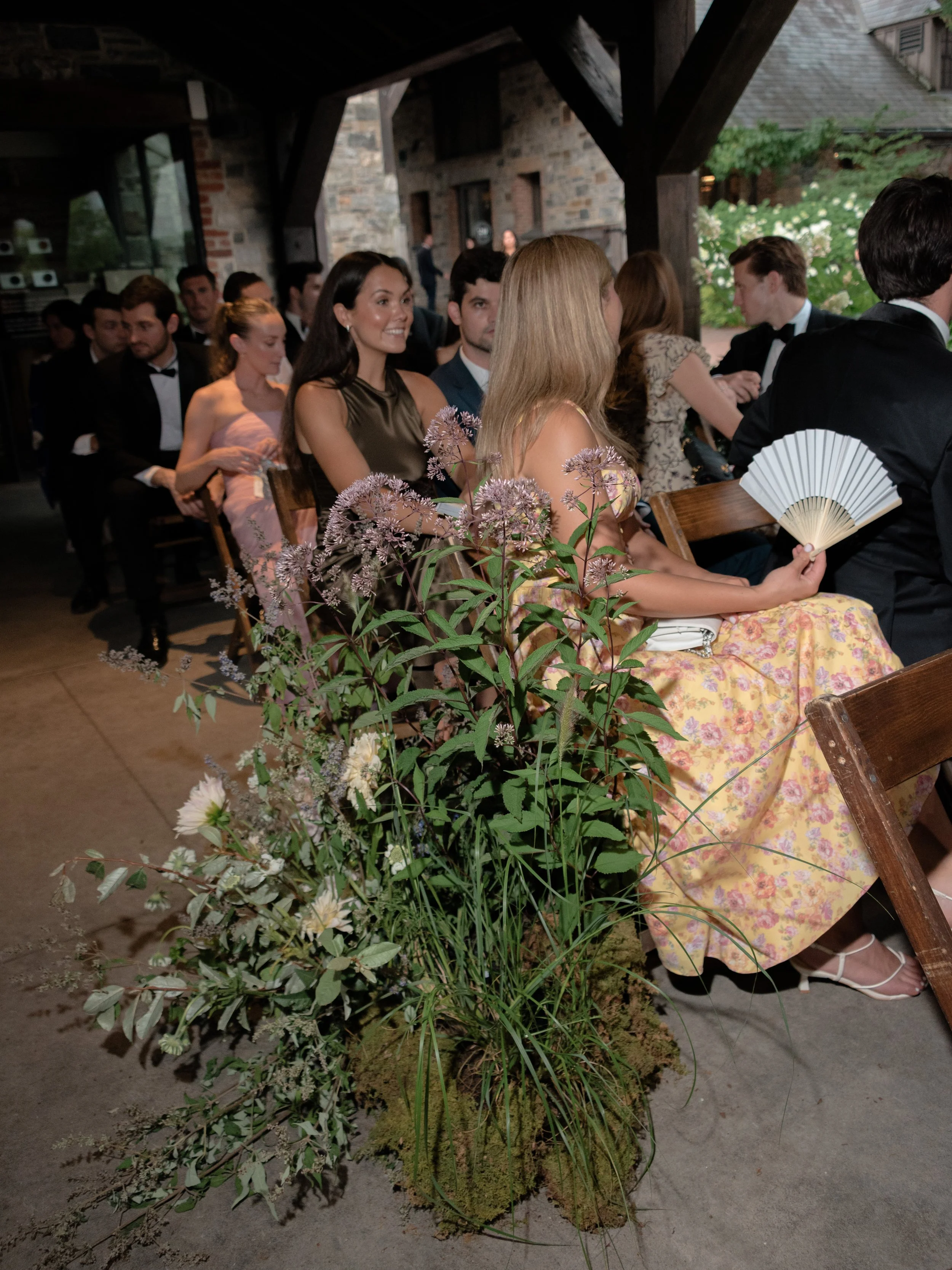 Guests take their seats beneath the pergola.